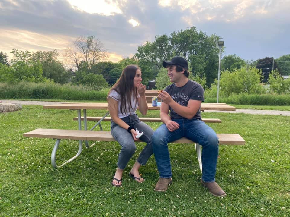 Young couple sharing a snack at sunset