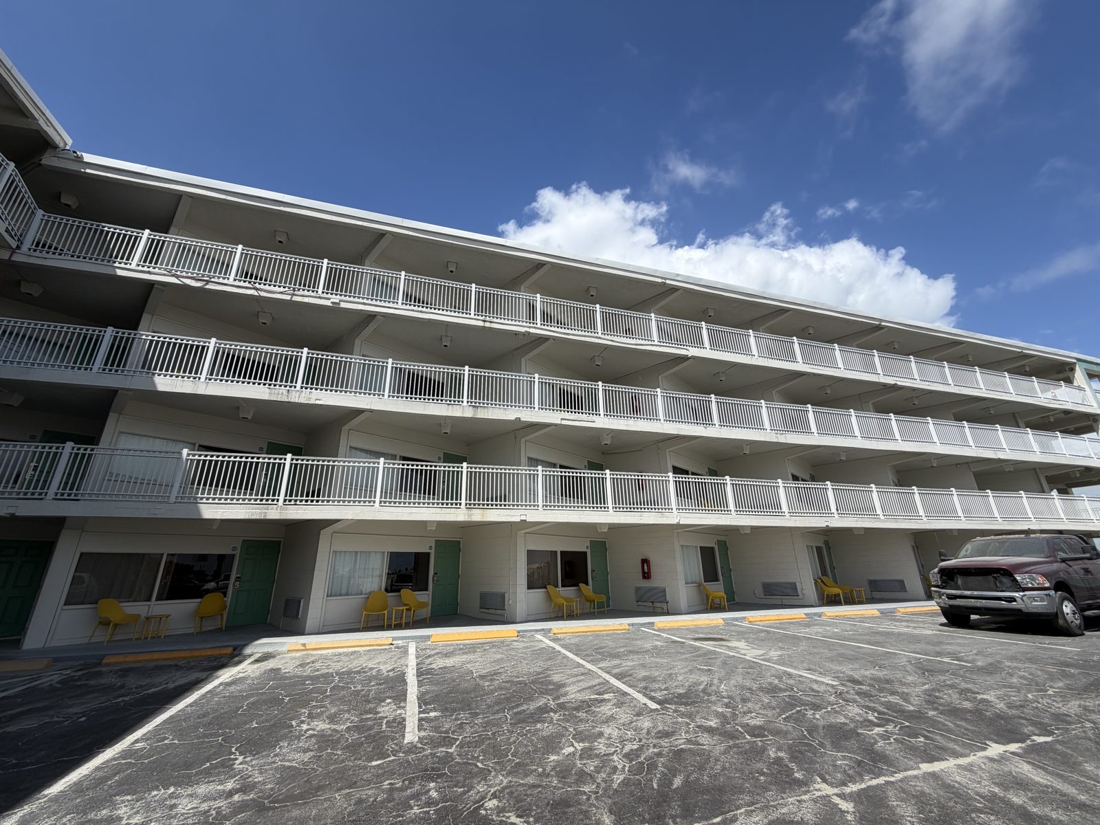 Chateau Mar Resort building face after restoration with white railings on every level