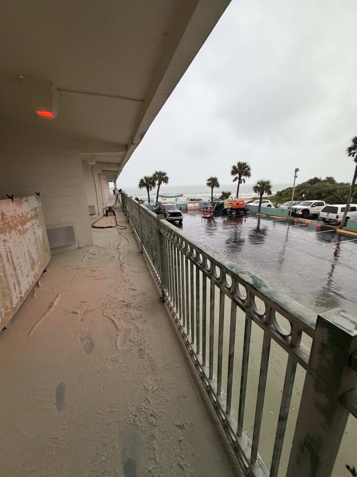 Chateau Mar Resort walkway during dustless blasting with the ocean behind