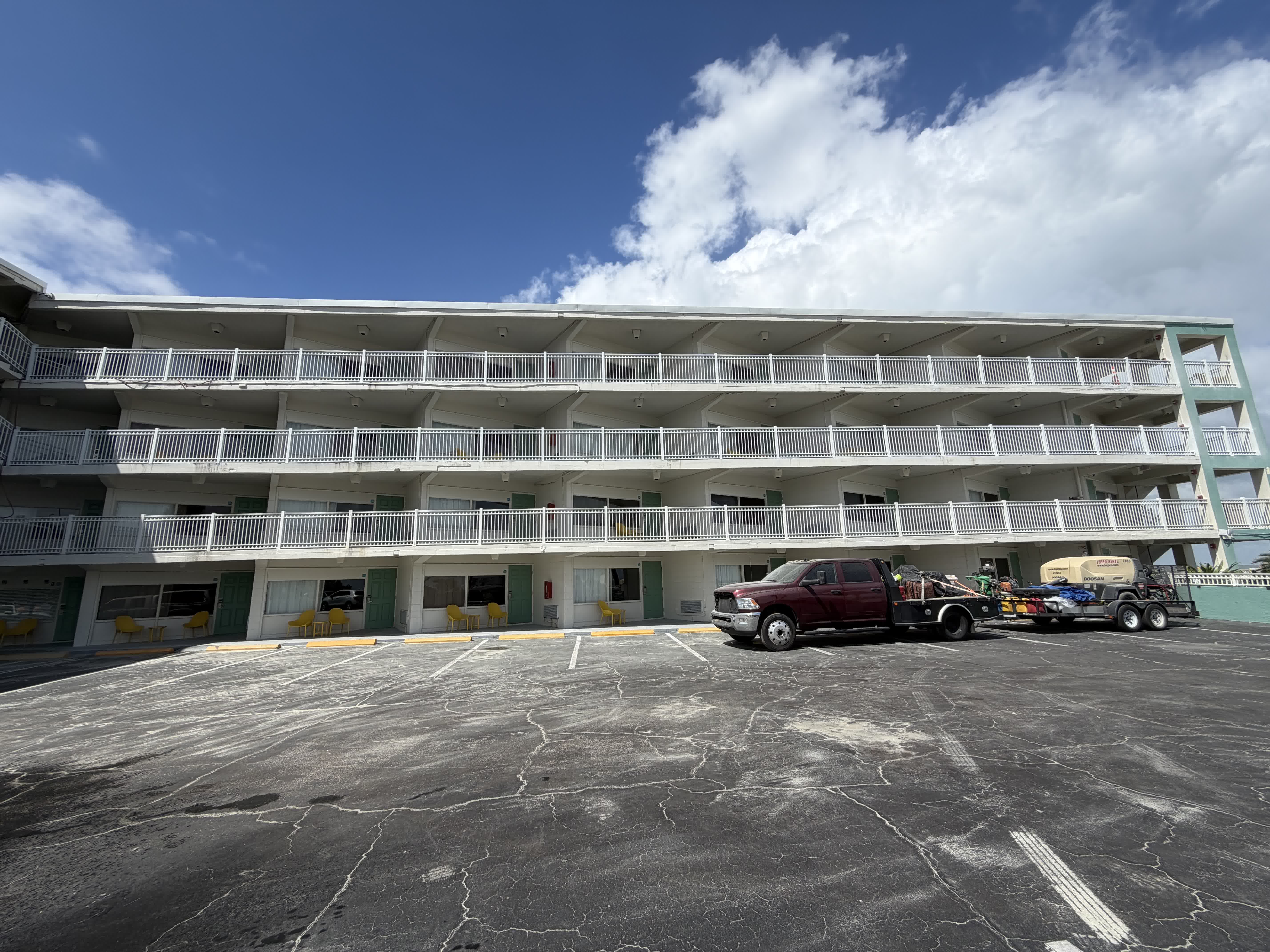 Hotel exterior during active project — Legacy Surface Prep equipment on site
