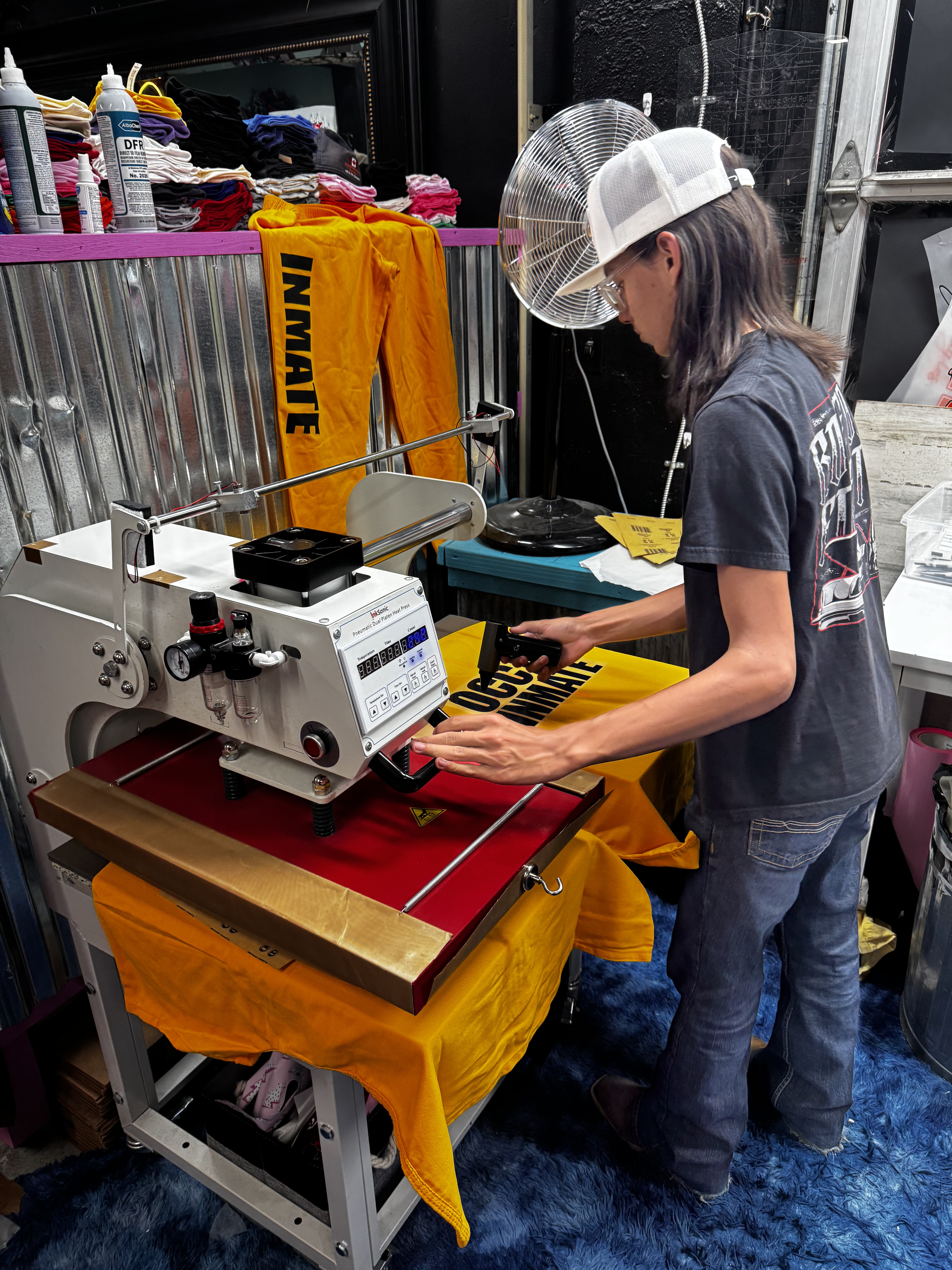 Tyler pressing inmate uniforms at JP's Custom Design and Printing