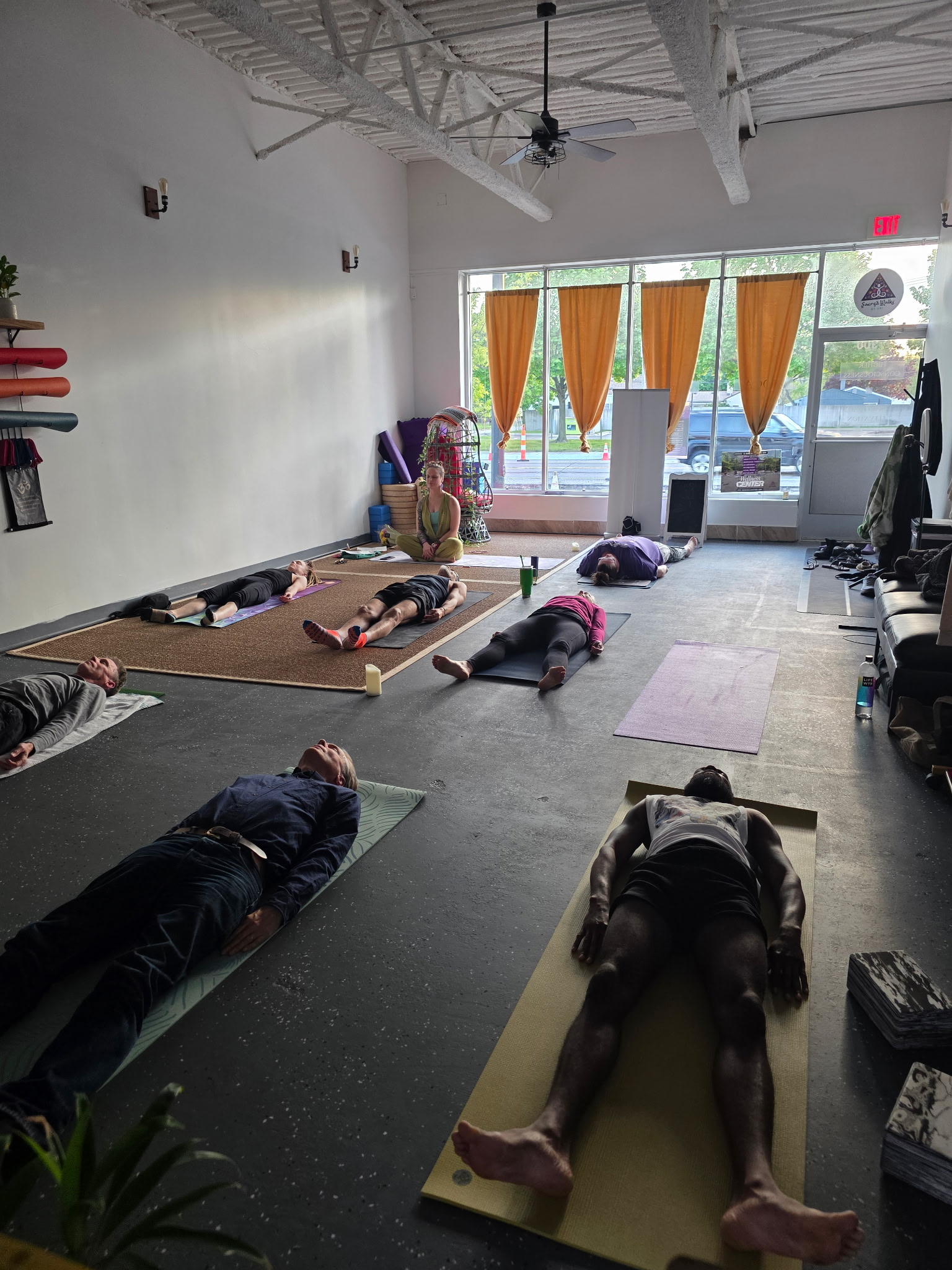 Savasana rest pose during yoga class at Sacred Walks By Uni studio