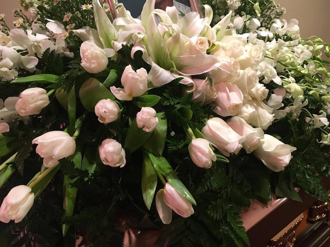 Blush tulips lilies and orchids casket spray