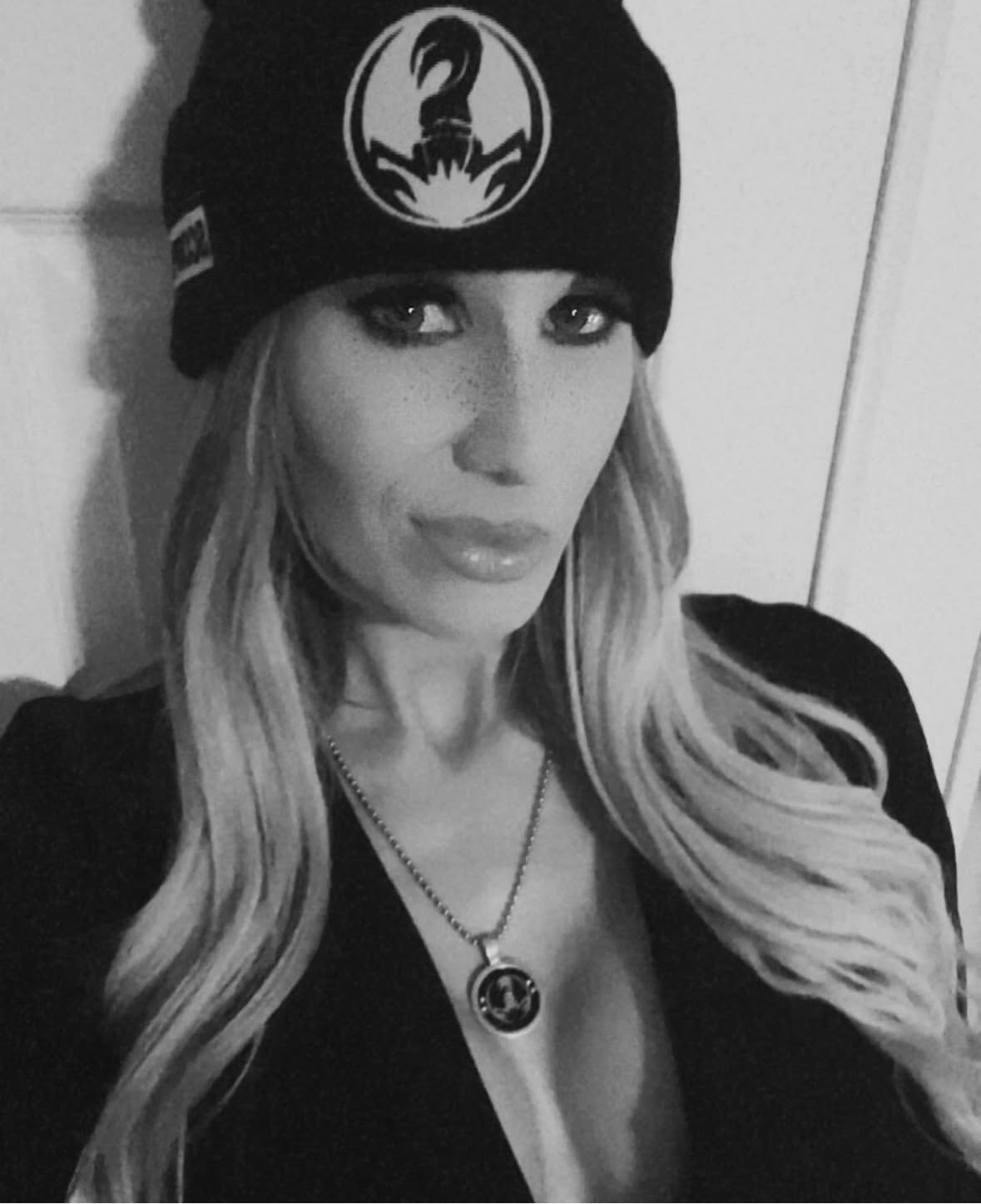 Black beanie. Scorpion front and center. Silver pendant to match.