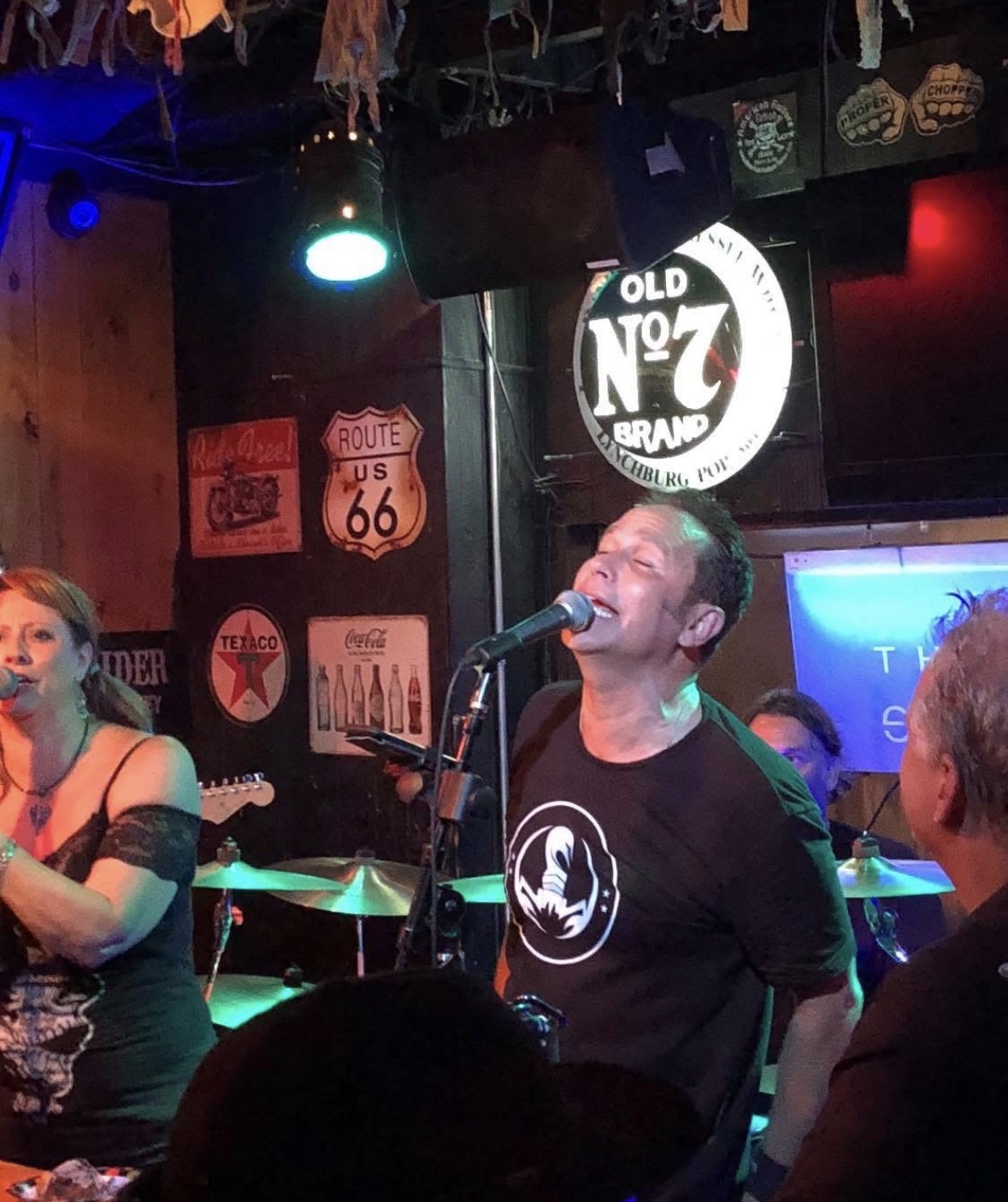 Owner Scooter Smith on stage — living out loud, wearing the brand he built.