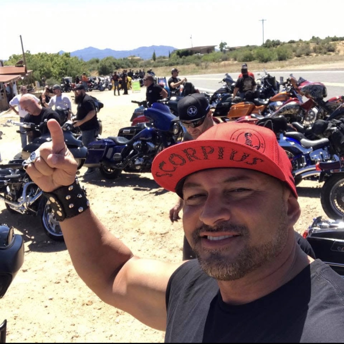 Thumbs up. Red Scorpius cap. Sunday rides, real people, real brotherhood.