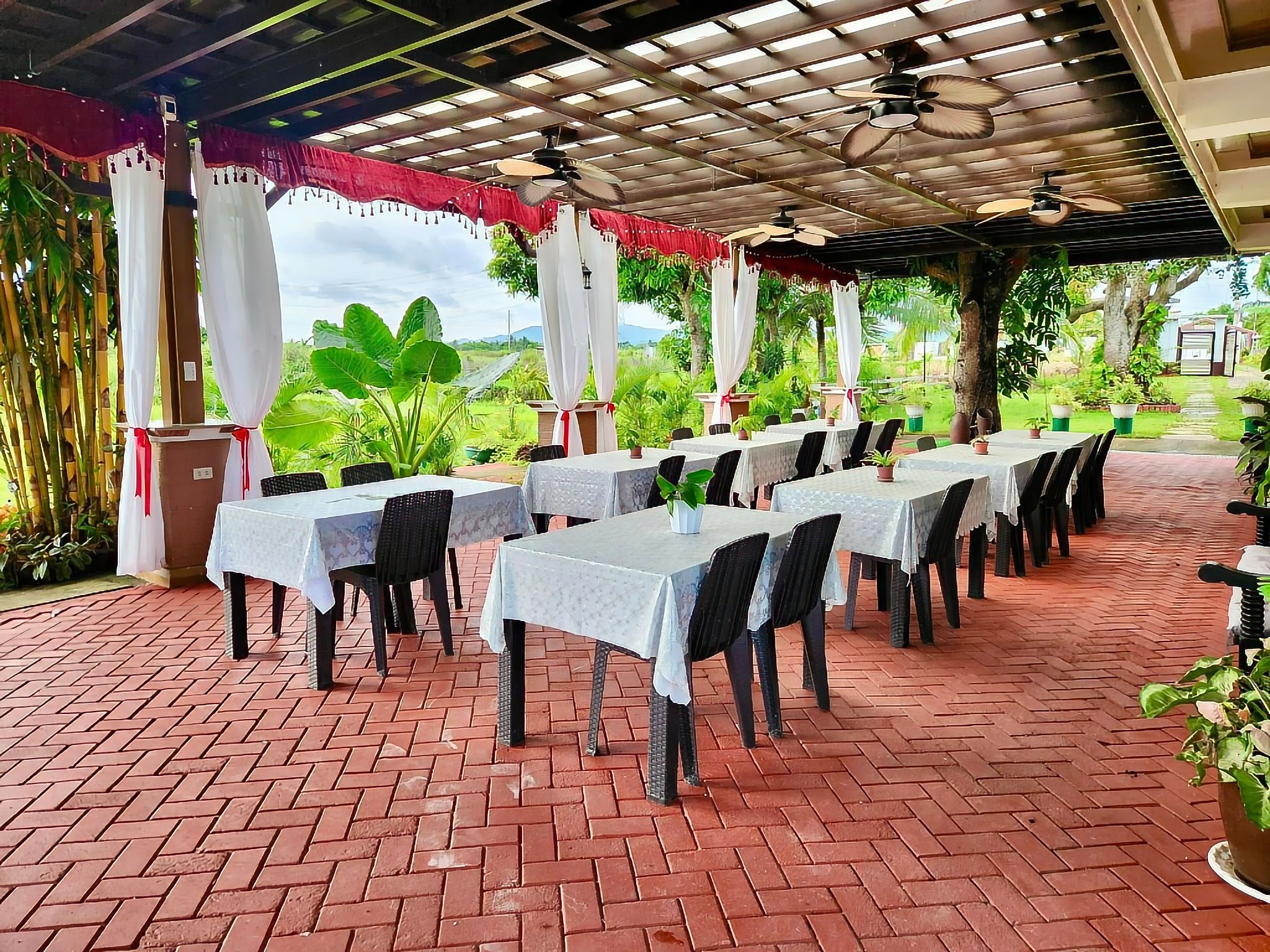 Open-air dining pavilion with garden views at The Oasis Resort Bicol