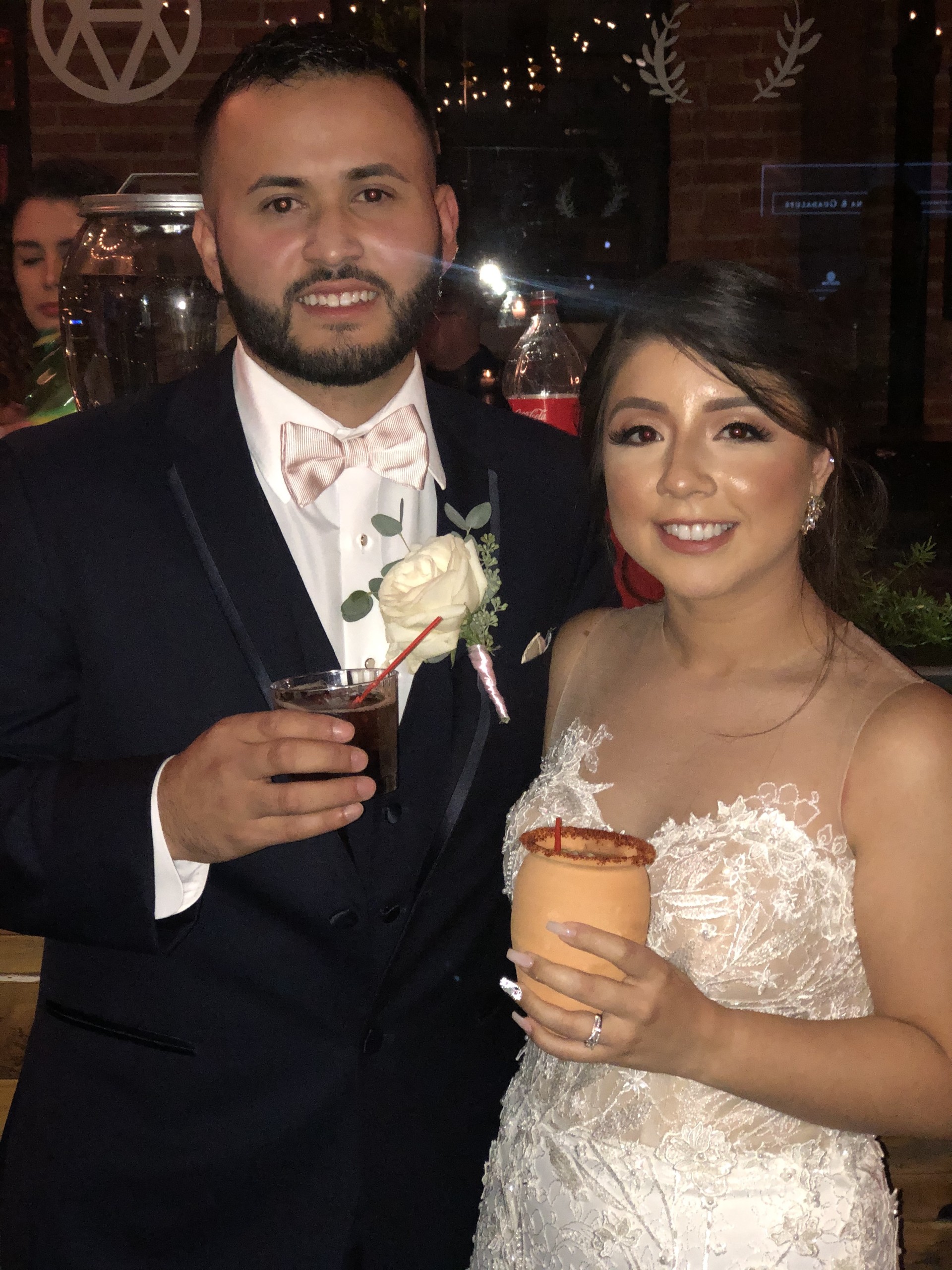 A newlywed couple toasting with cocktails crafted by Sip with CJ