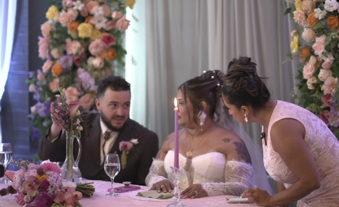 Cynthia coordinating at a couple's sweetheart table during their wedding reception