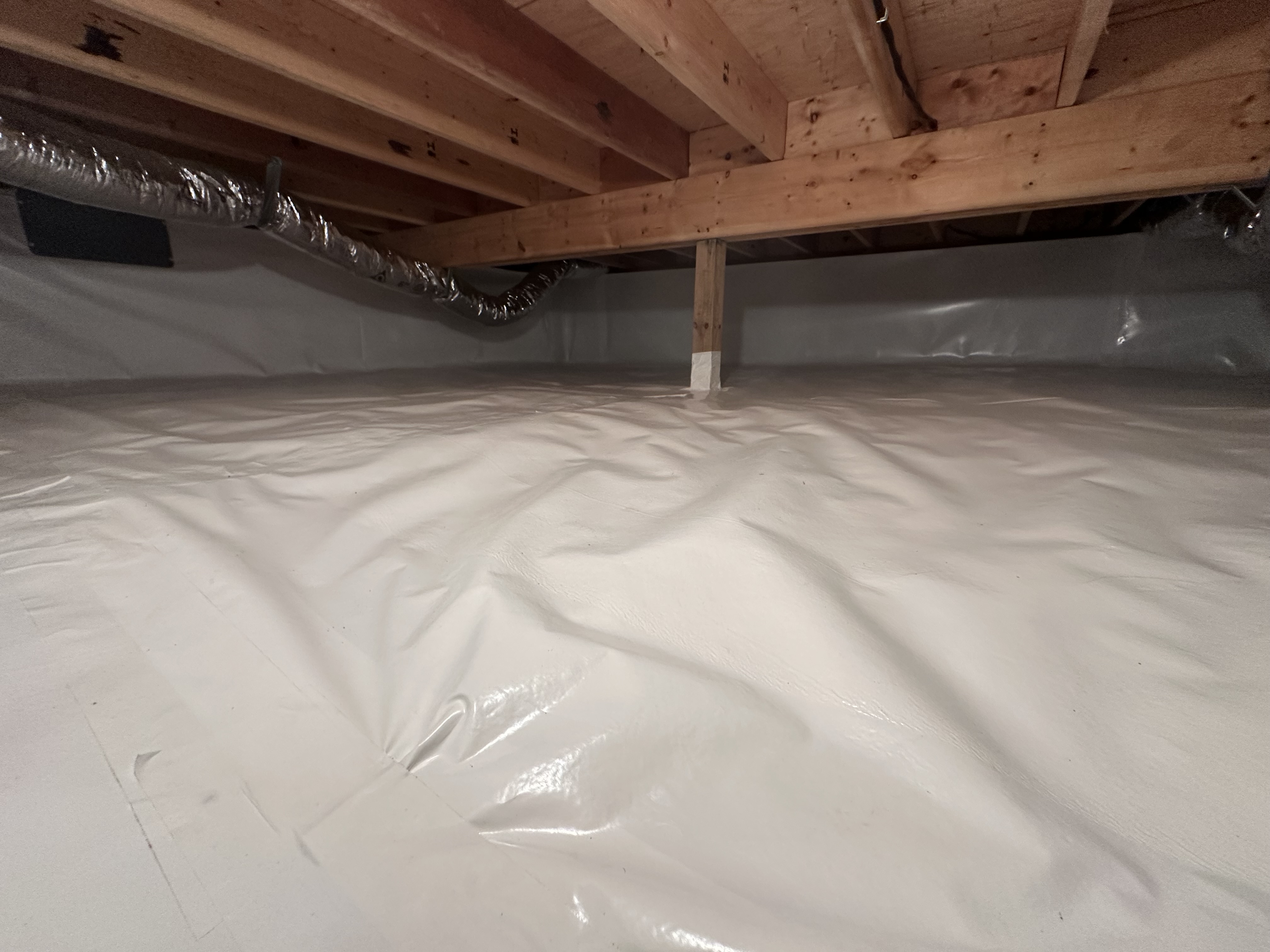 Clean encapsulated crawlspace with HVAC ducts — full perimeter coverage