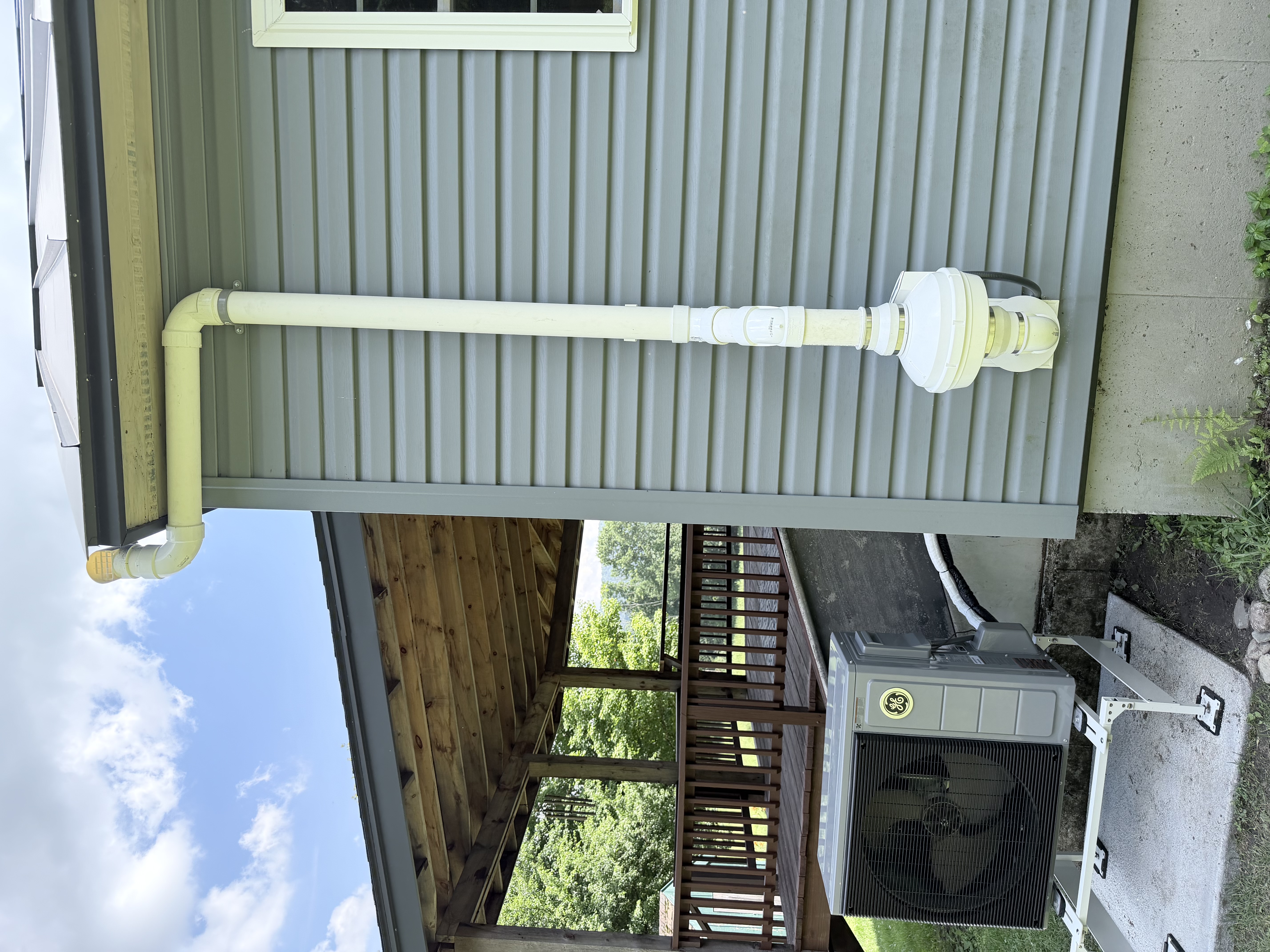 Exterior radon pipe exit above roofline — safe radon exhaust routing