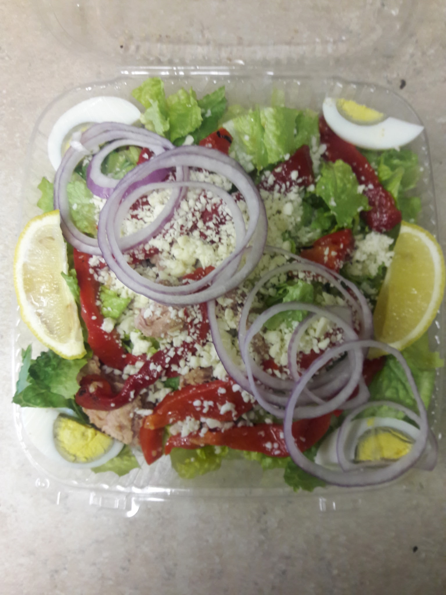 Fresh salad with feta, red peppers, onions and egg