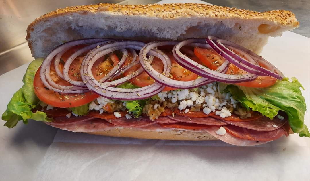 Loaded hoagie with salami, onions, tomatoes and feta