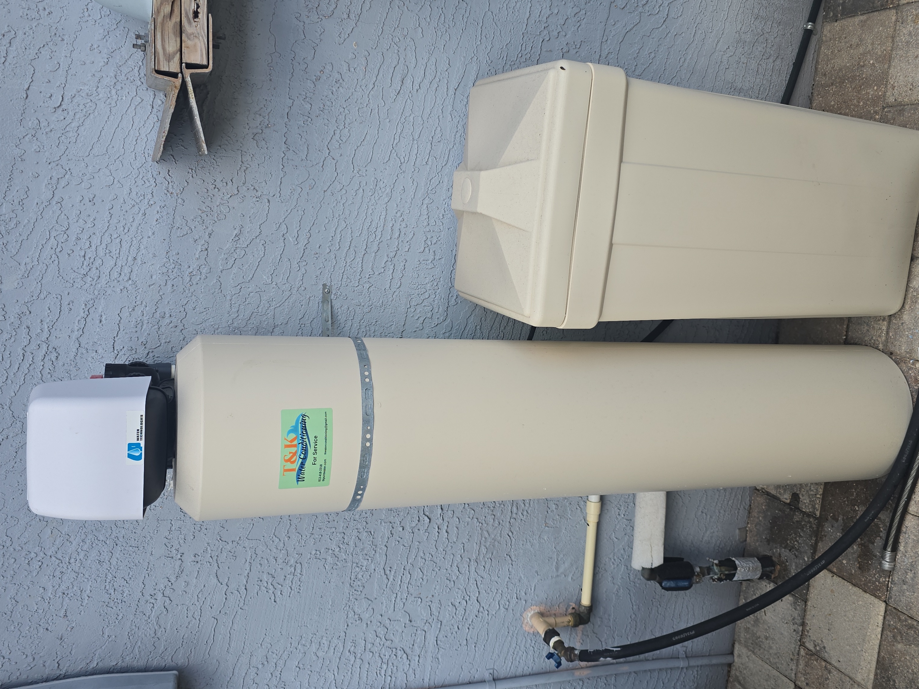 T&K Water Conditioning water softener with digital control head installed outside home in Tampa Bay