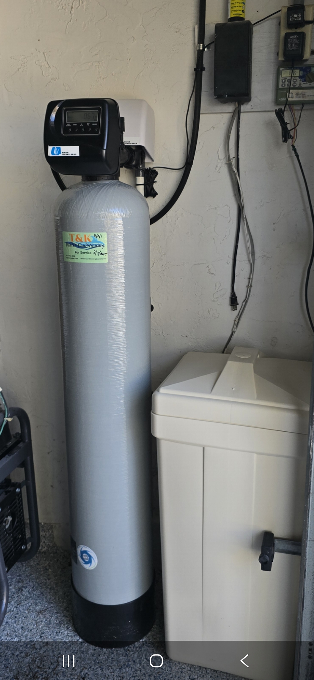 T&K Water Conditioning water softener installed in outdoor utility area of Florida home
