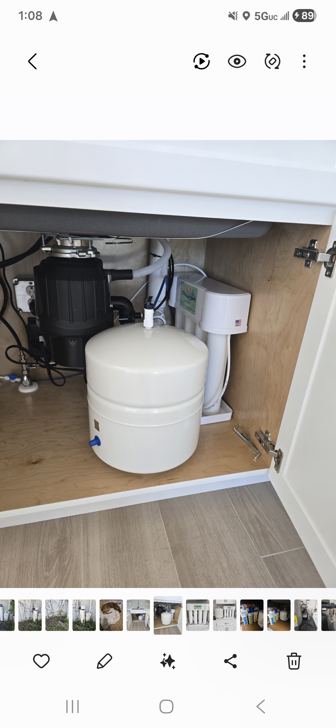 Reverse osmosis drinking water system installed under kitchen sink with storage tank