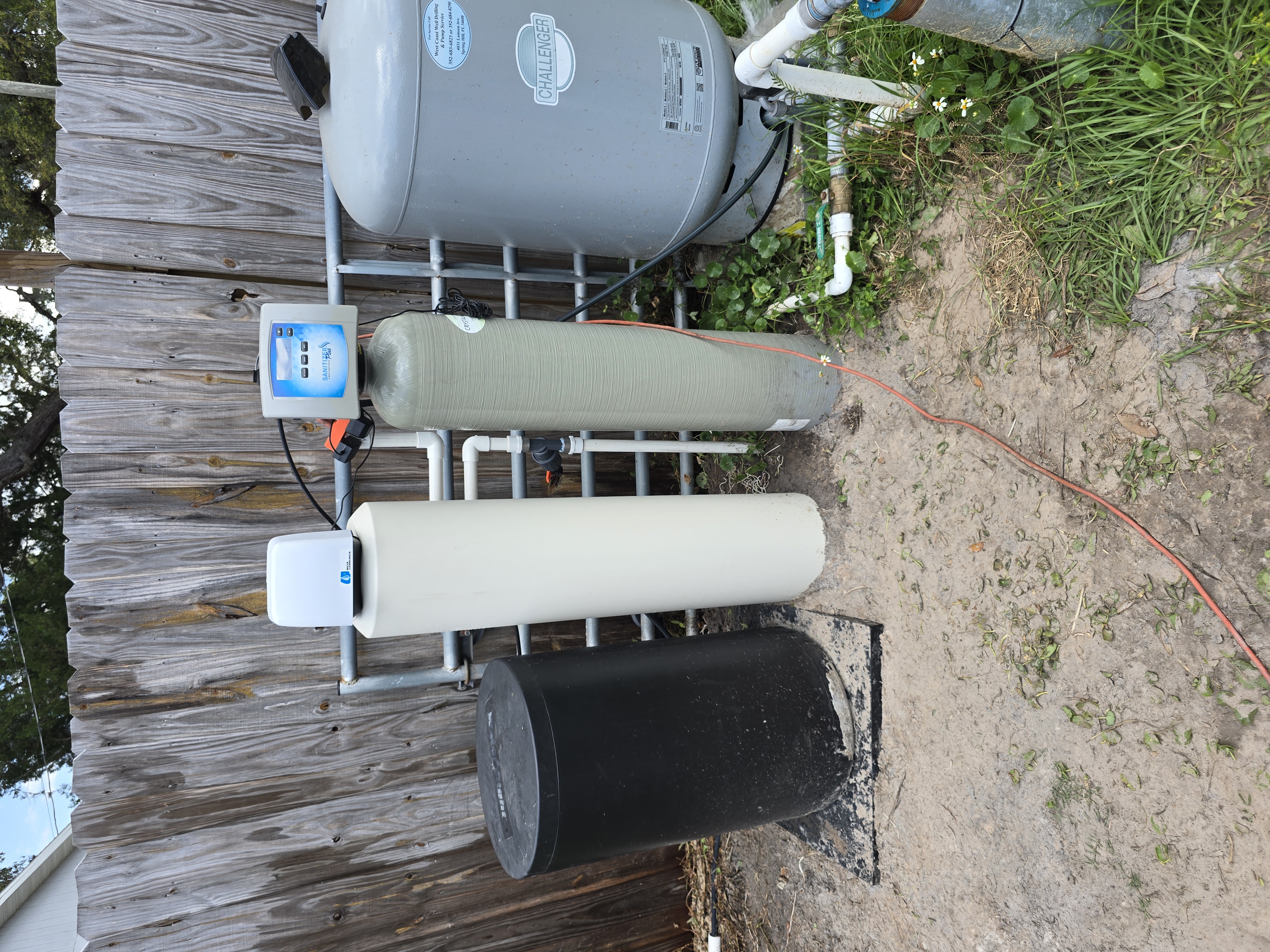 T&K Water Conditioning water softener with salt tank installed in garage in Tampa Bay
