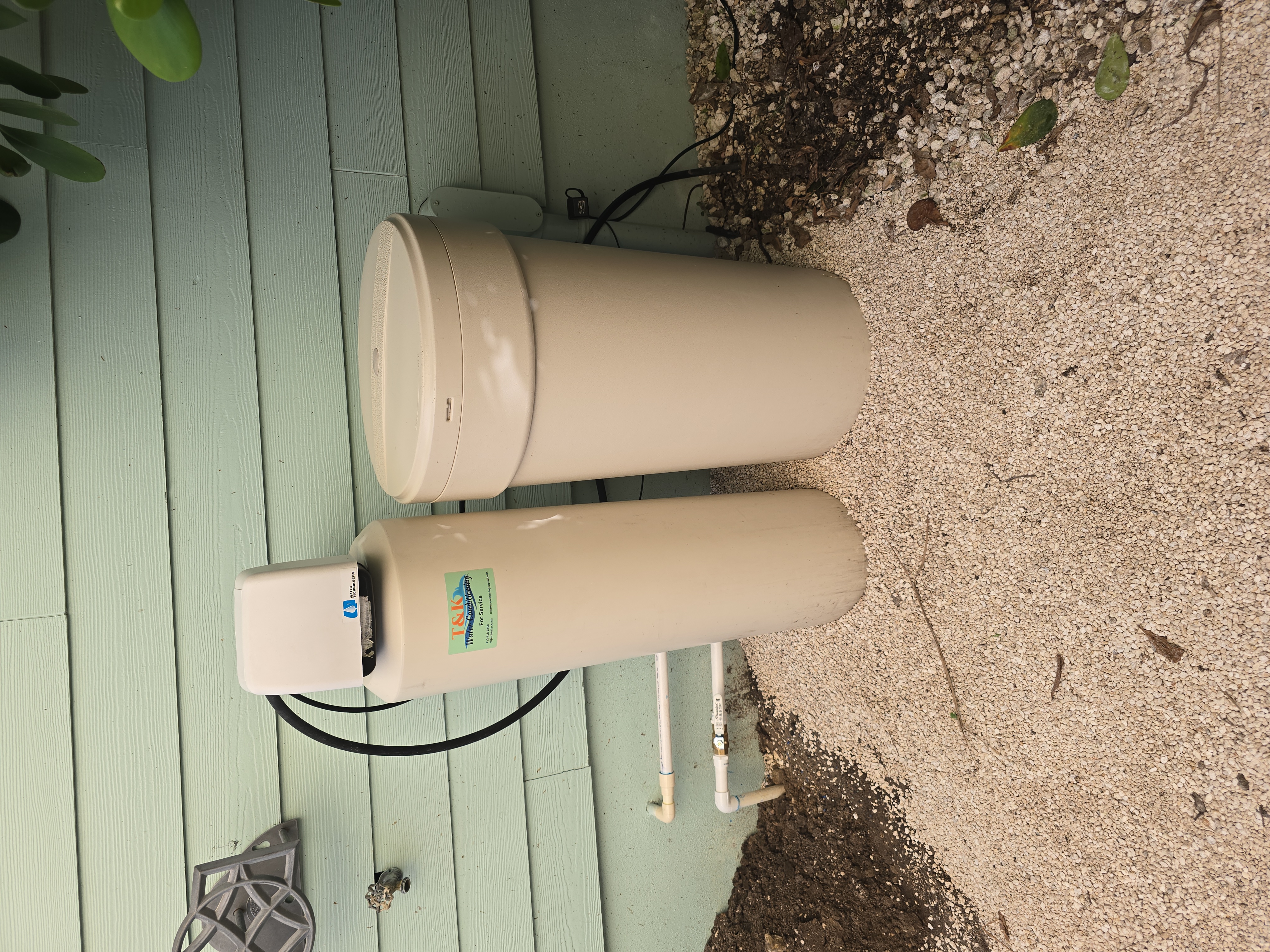 T&K Water Conditioning dual-tank rental system with Impression Plus softener and iron filter outside Florida home