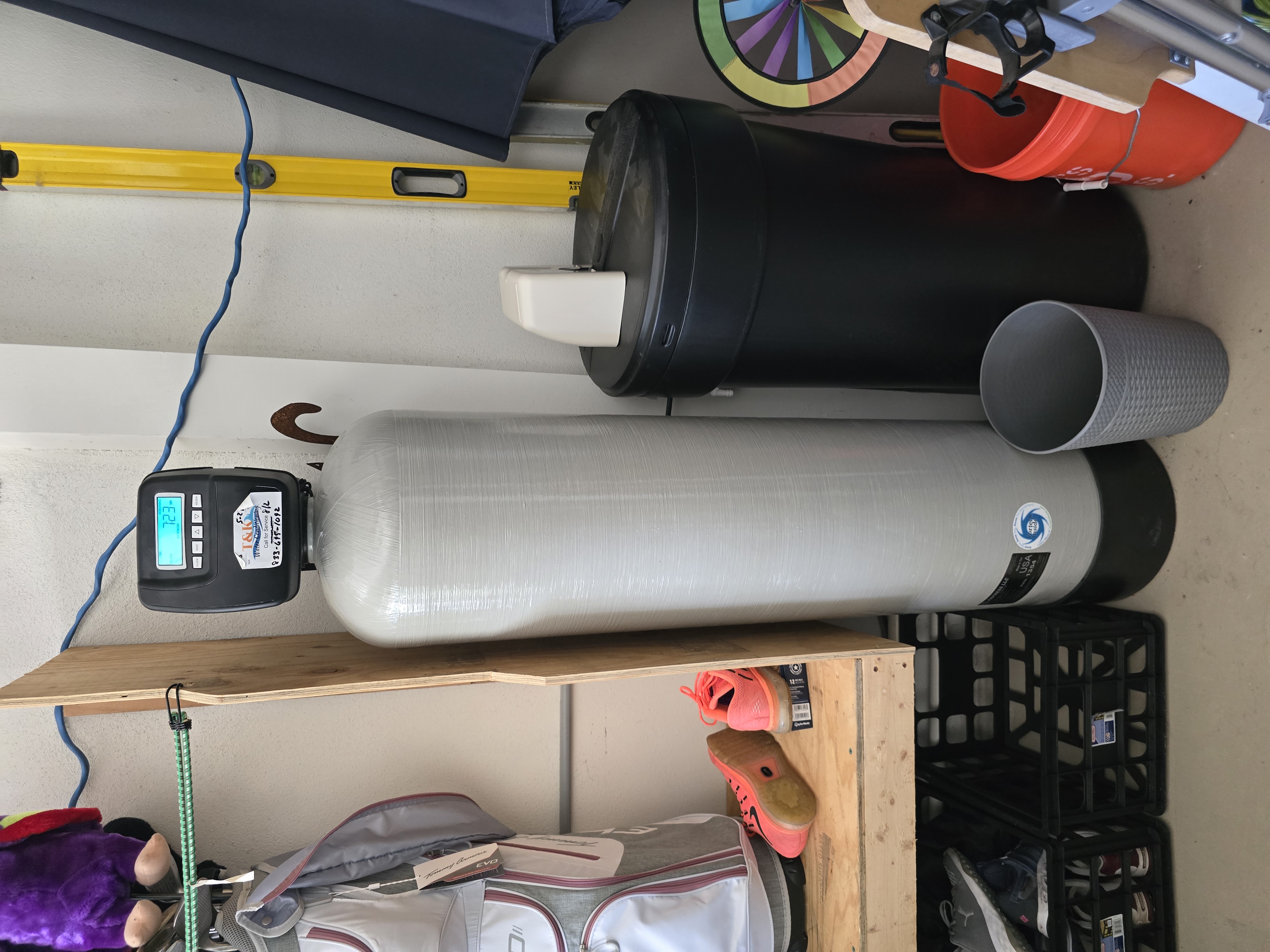 T&K Water Conditioning water softener with round salt tank in garage in Tampa Bay