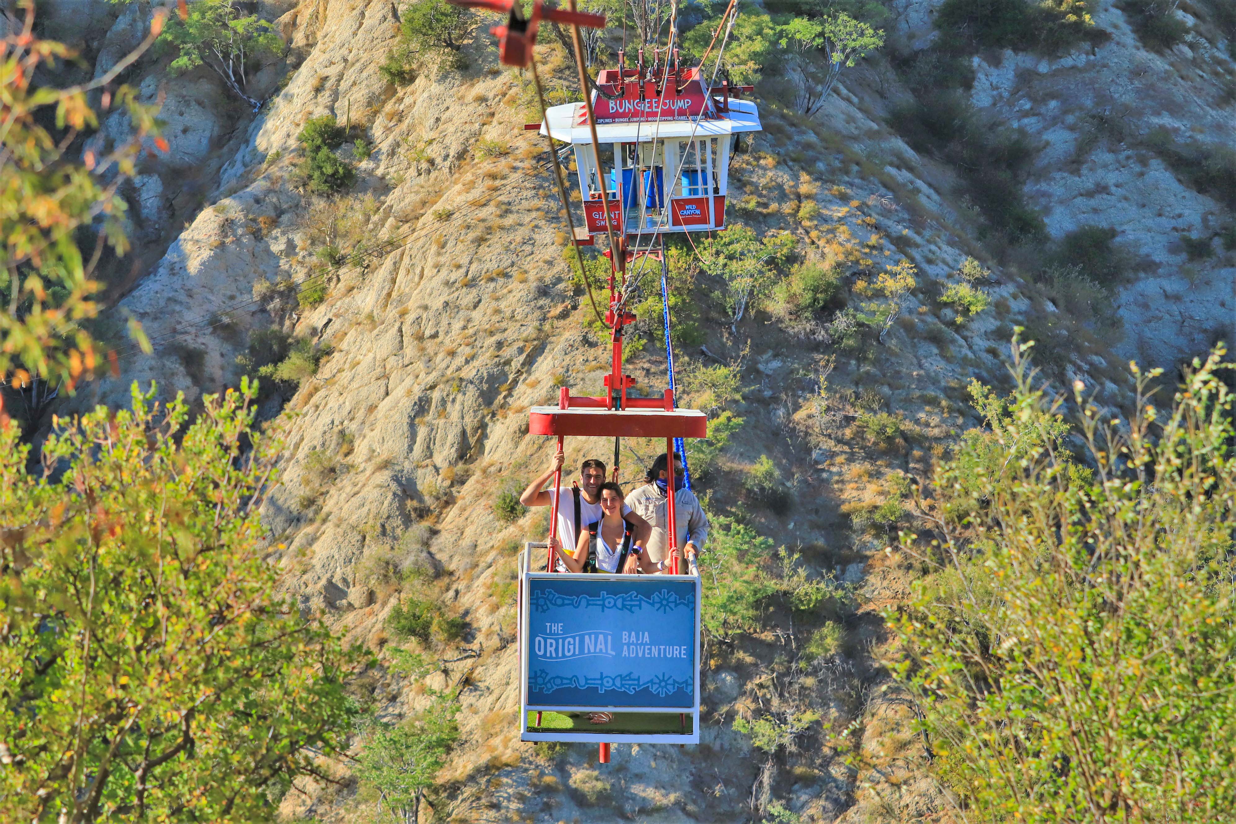 Glass-floored gondola at Wild Canyon Adventures with guests preparing for bungee jump