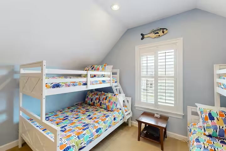 Bayside home bunk bed room with colorful bedding