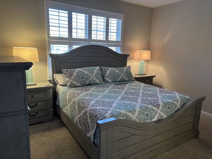 Cozy bedroom with gray furniture and damask bedding