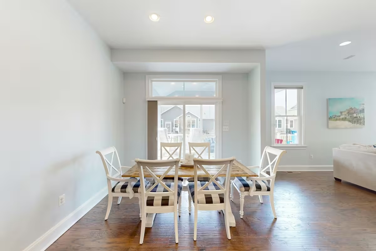 Farmhouse dining table with cross-back chairs and patio view