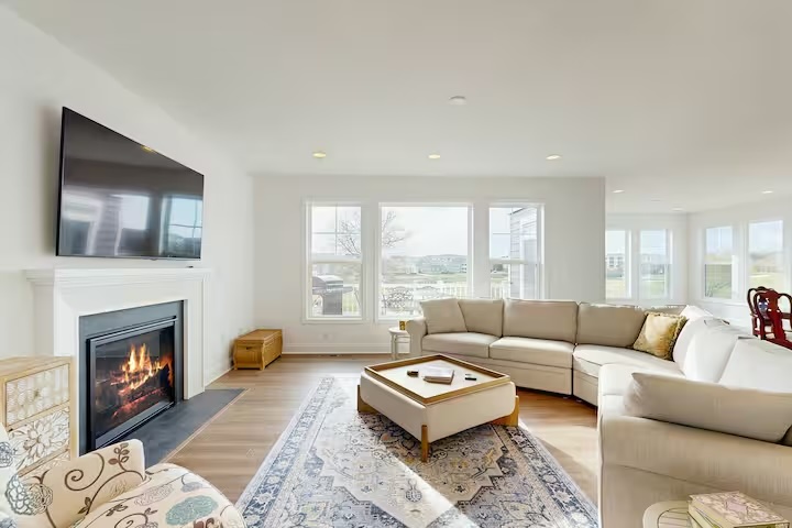 Cozy living room with fireplace sectional sofa and natural light