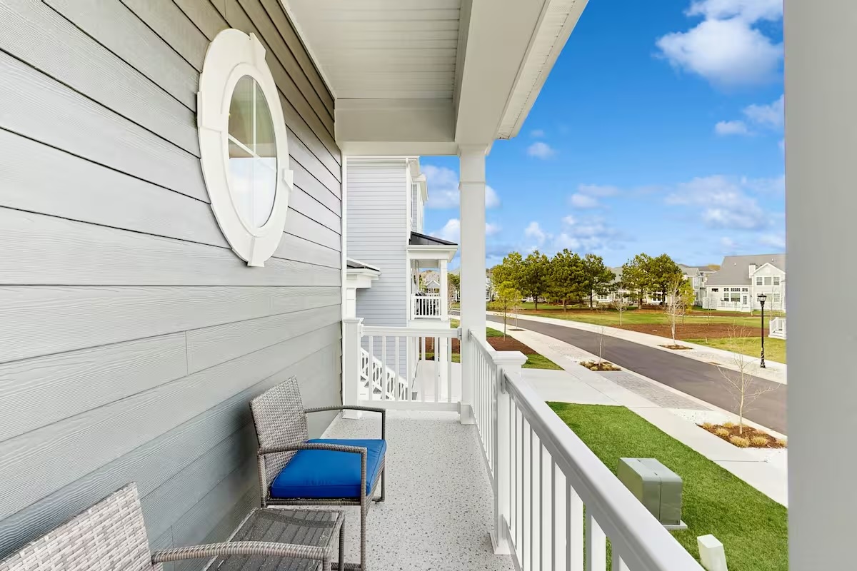 Private balcony with blue cushion chair overlooking the community