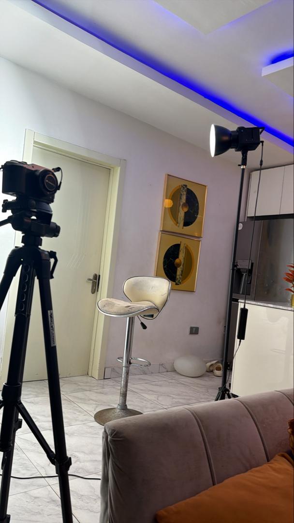 R Visionz Africa episode — studio setup with camera, chair, and blue ambient lighting
