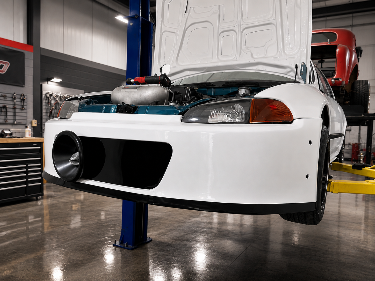 White race car build on the lift at J&J Imports