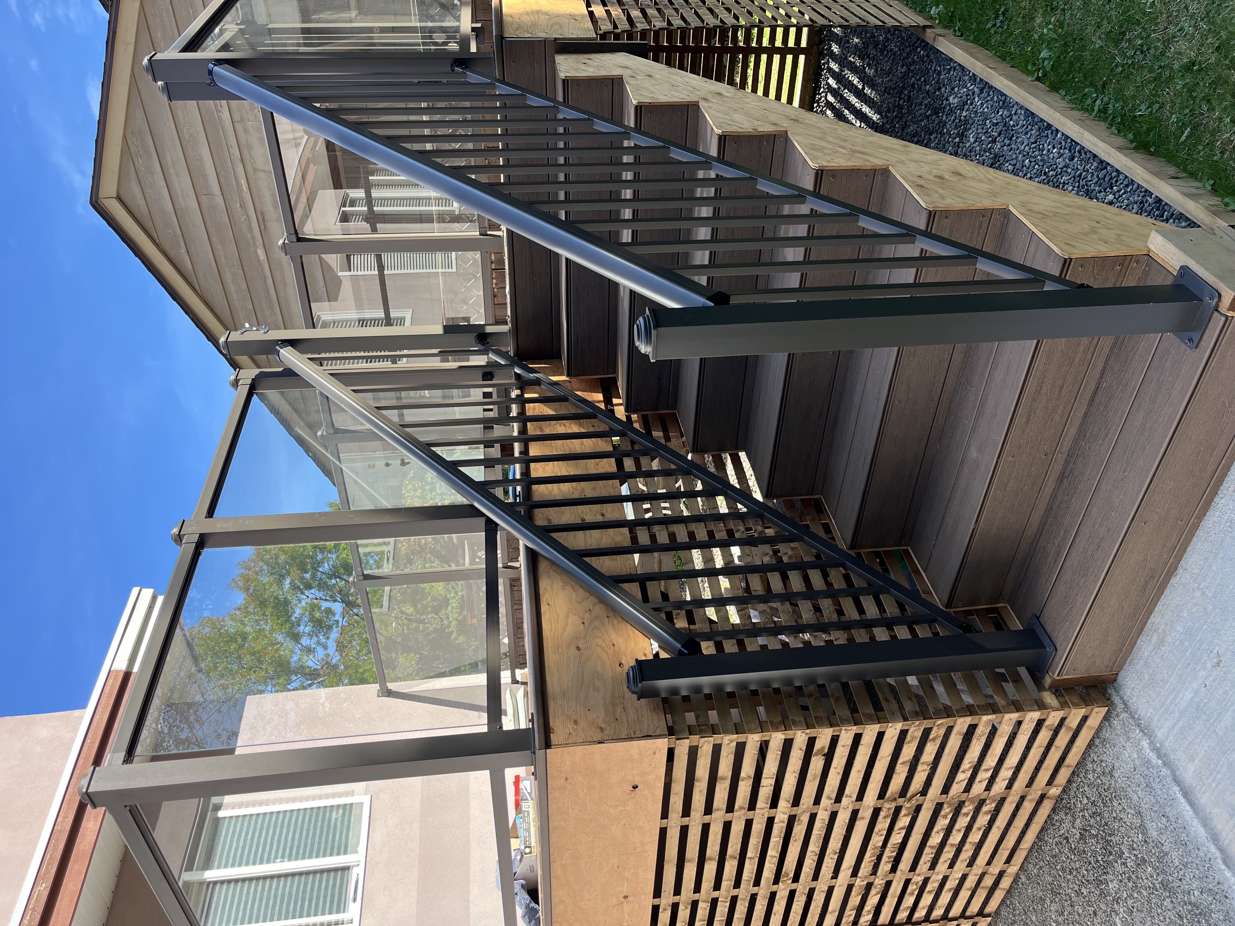 Ryan's composite deck and stairs with glass railings by Tarak Construction