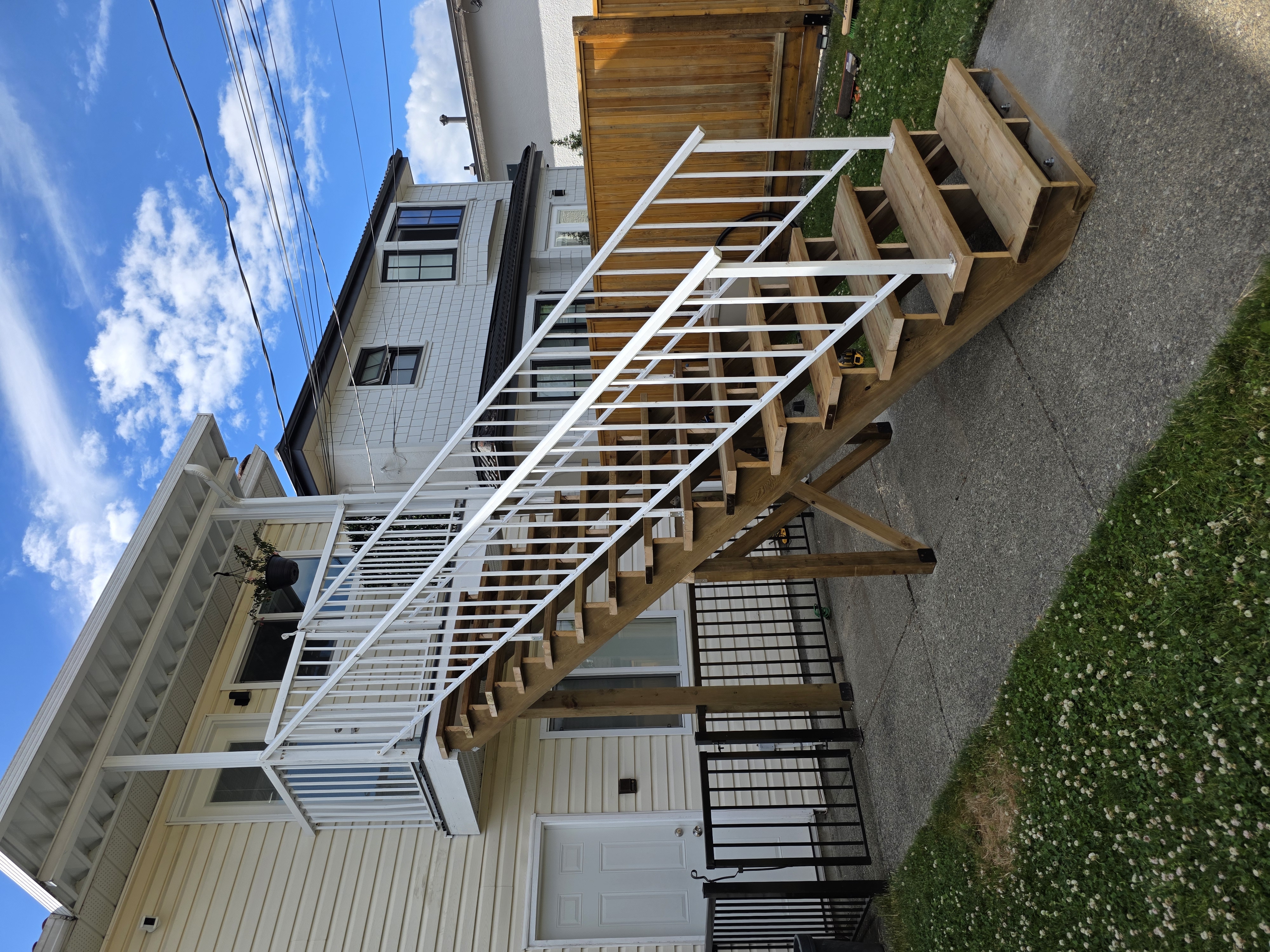 Jeane's back porch stair replacement with white railing by Tarak Construction