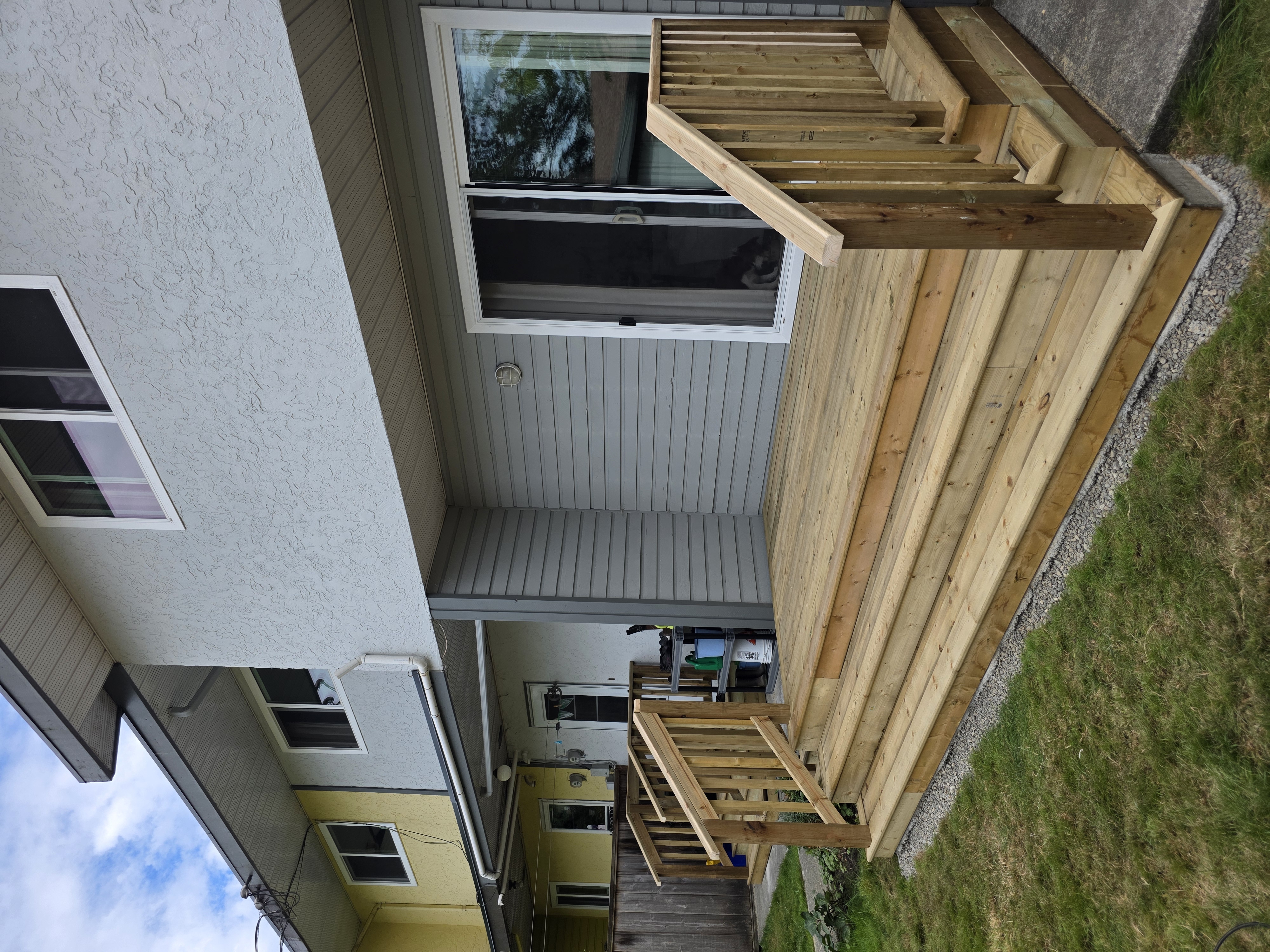Paul's laundry room landing with steps and handrails by Tarak Construction