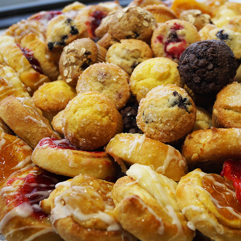 Pastry tray with muffins, danishes, and sweet treats
