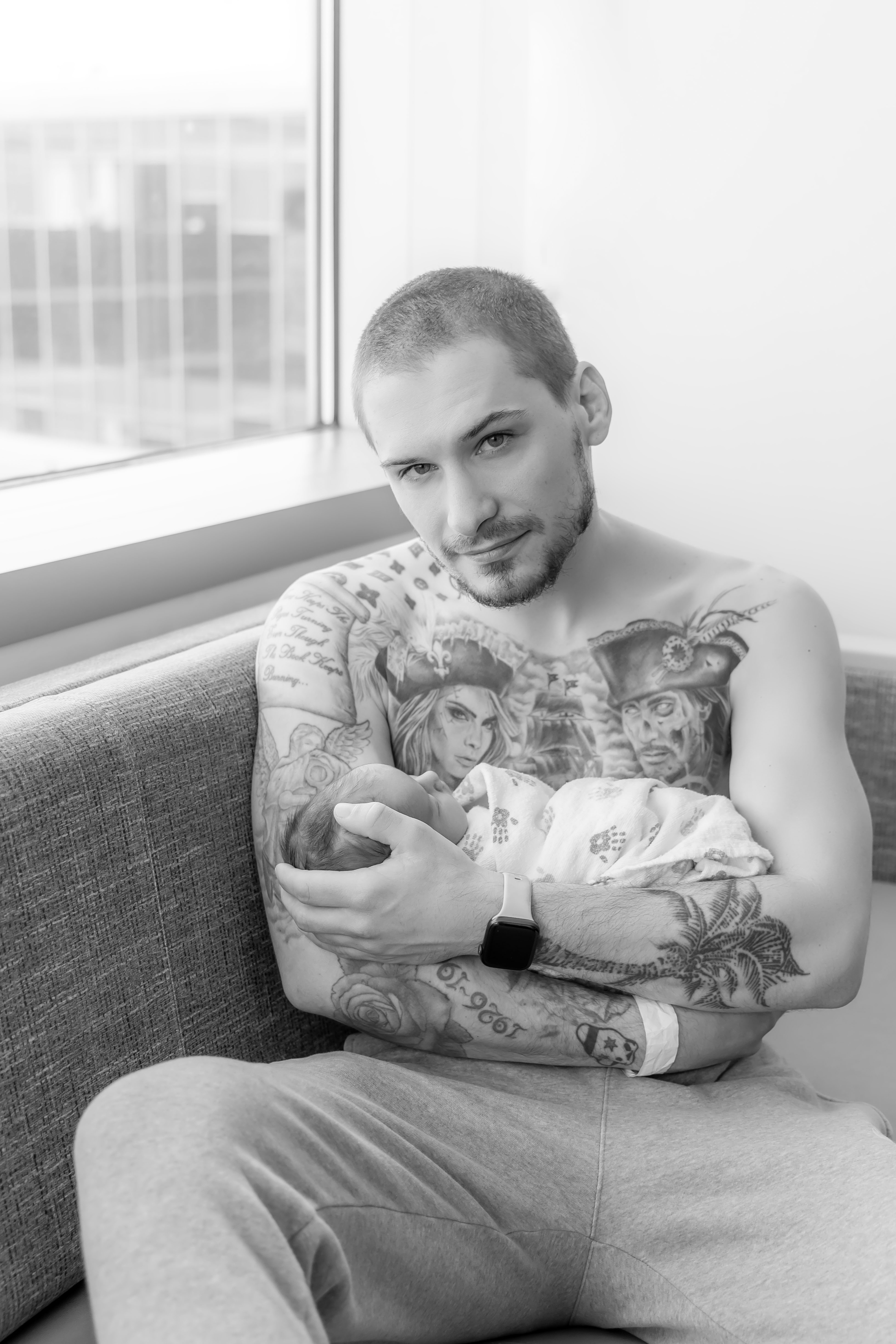 Fresh 48 — dad holding newborn skin-to-skin in hospital room — IDTPhoto