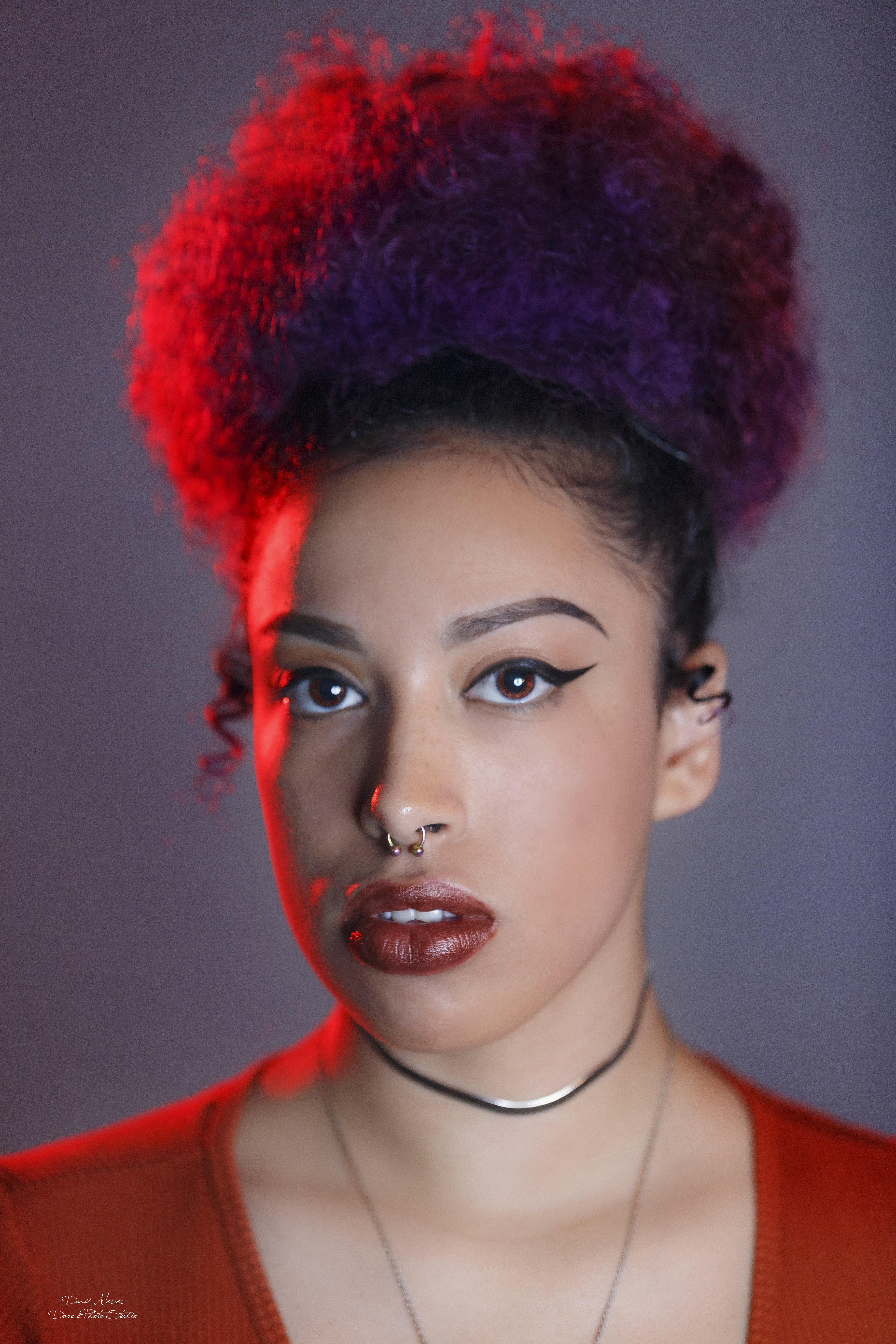 Fashion editorial portrait with beret and red jacket in blue-lit studio — IDT Photo Aurora IL
