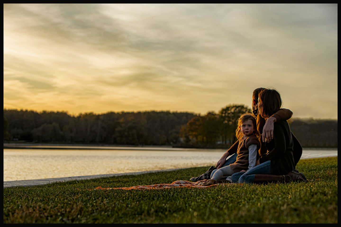 Family at golden hour by the lake