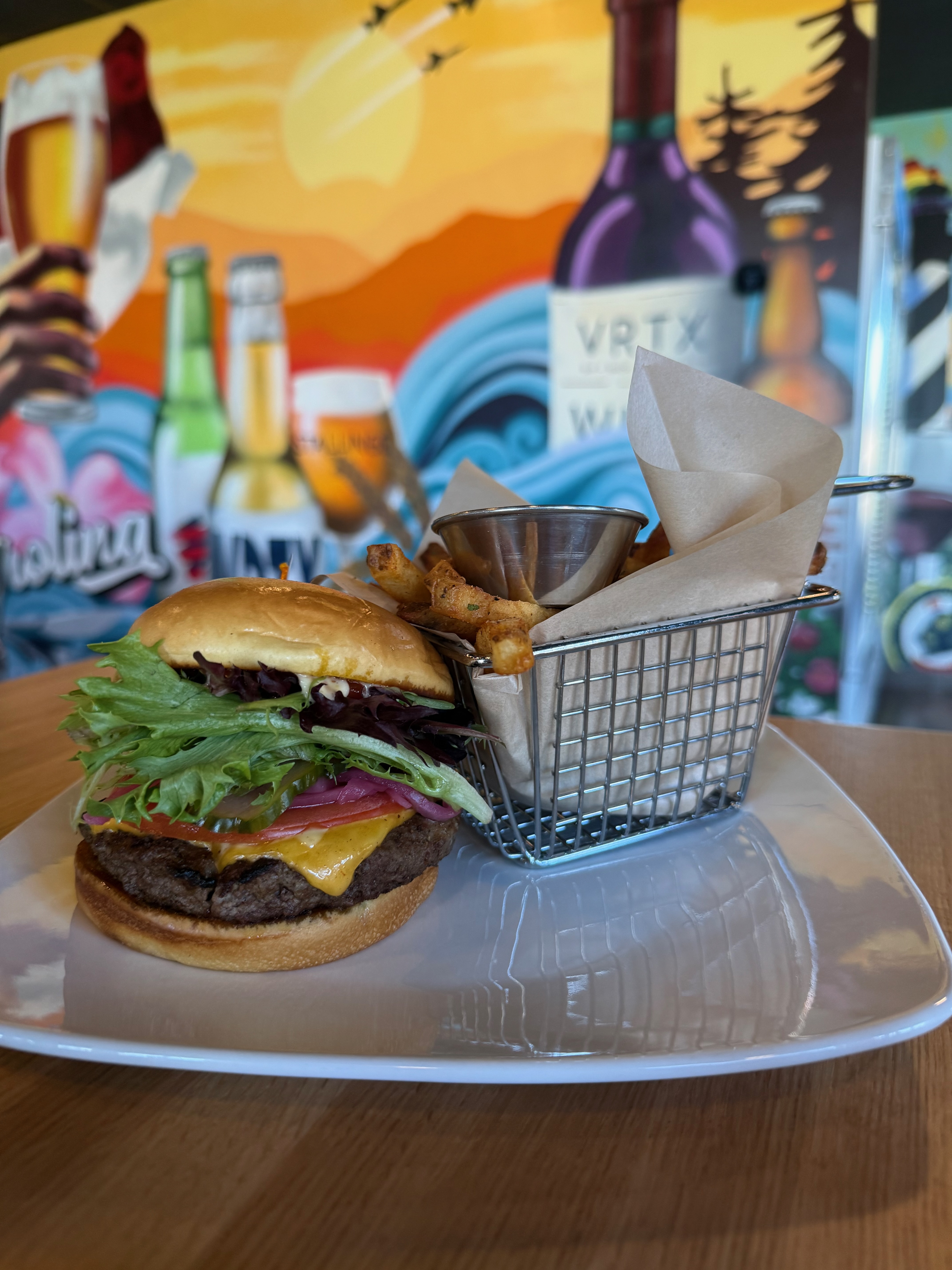 Classic Angus beef burger served with fries at The VRTX