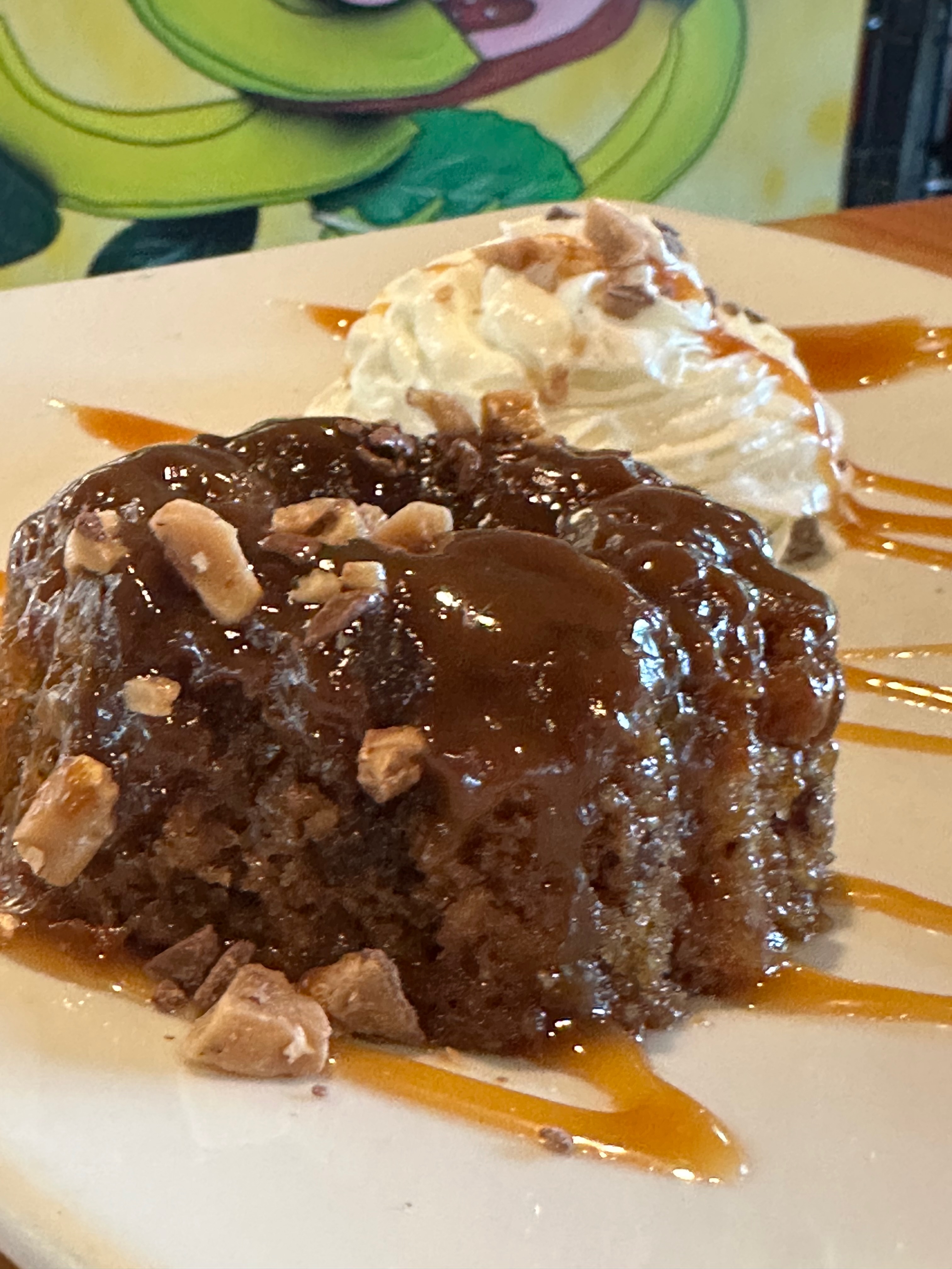 Sticky toffee pudding dessert with caramel and whipped cream