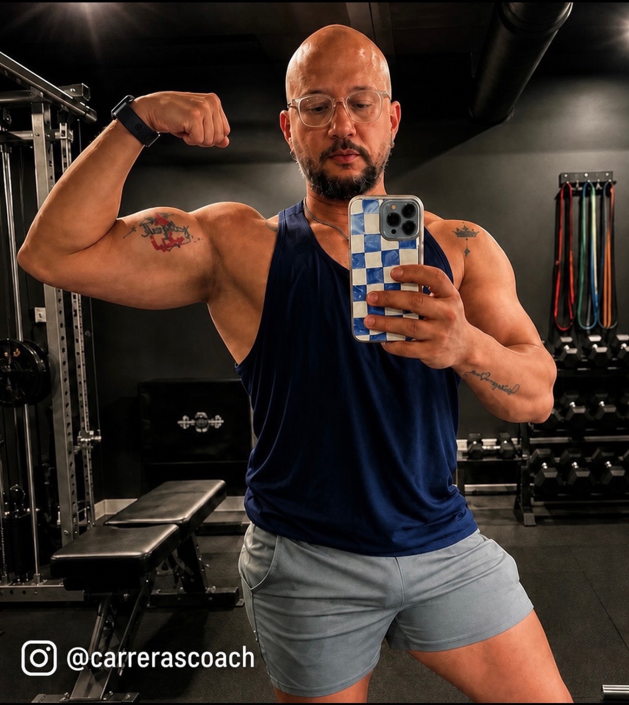 Coach Rey flexing bicep in the gym