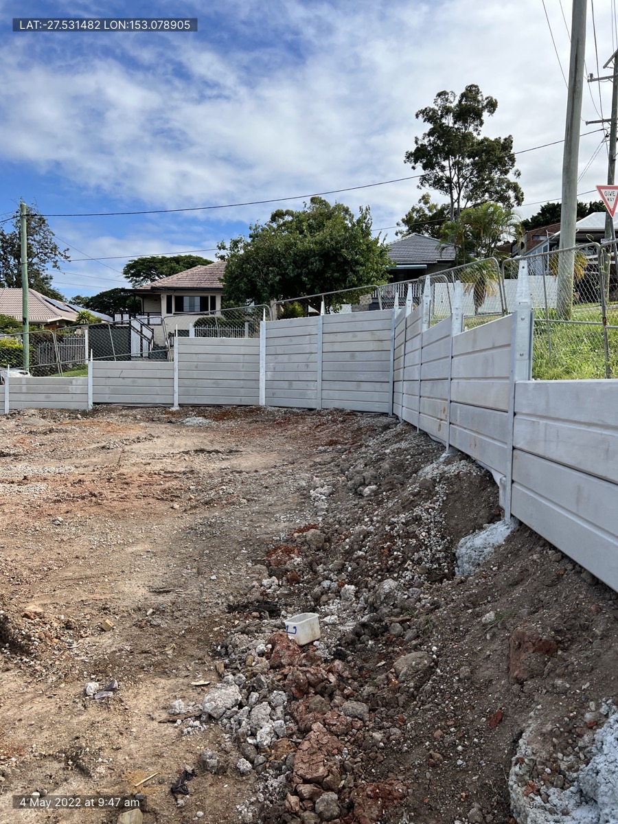 Concrete sleeper retaining wall installation on a residential site in Brisbane
