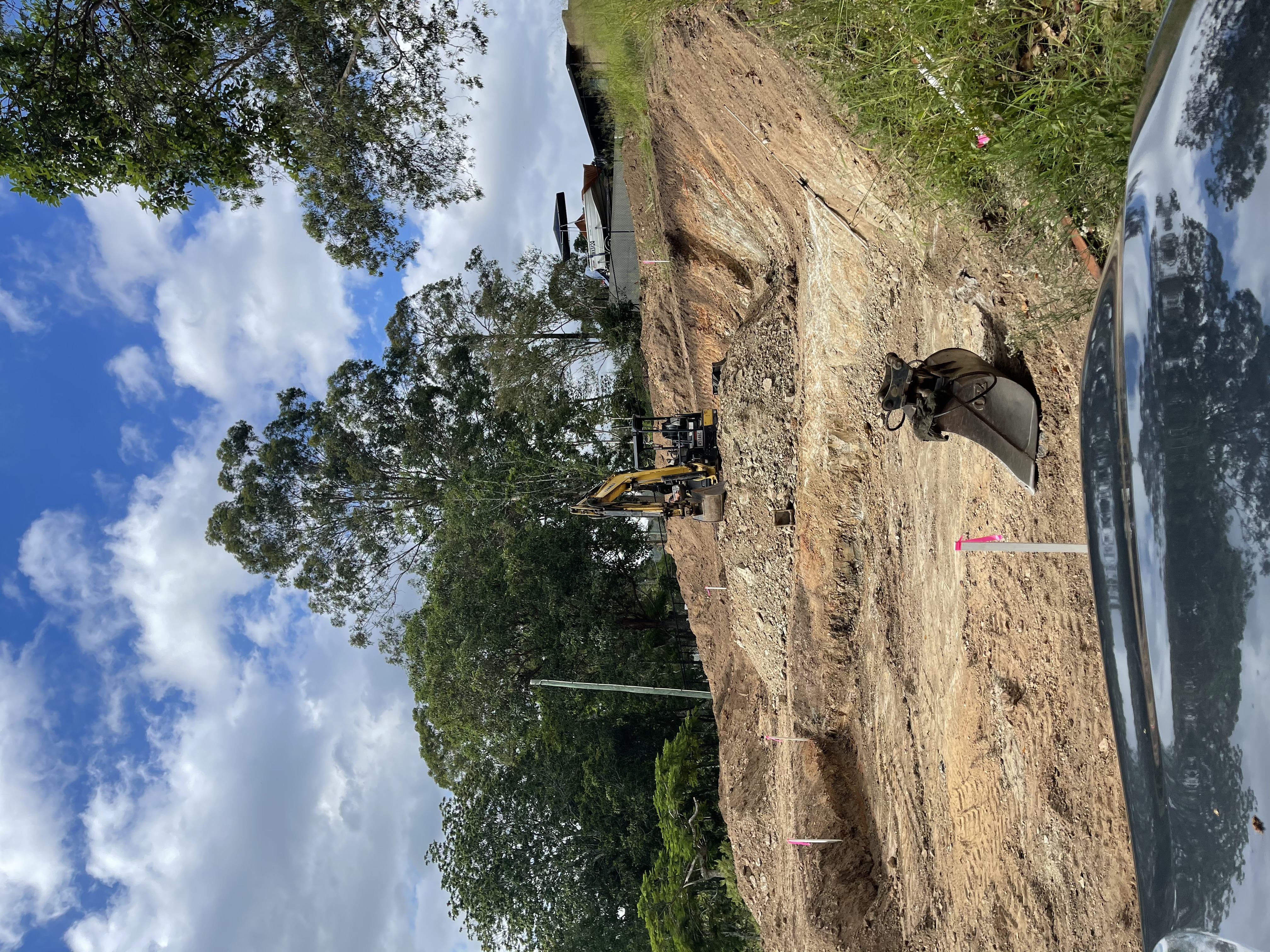 Excavator performing bulk earthworks on a residential site in Brisbane