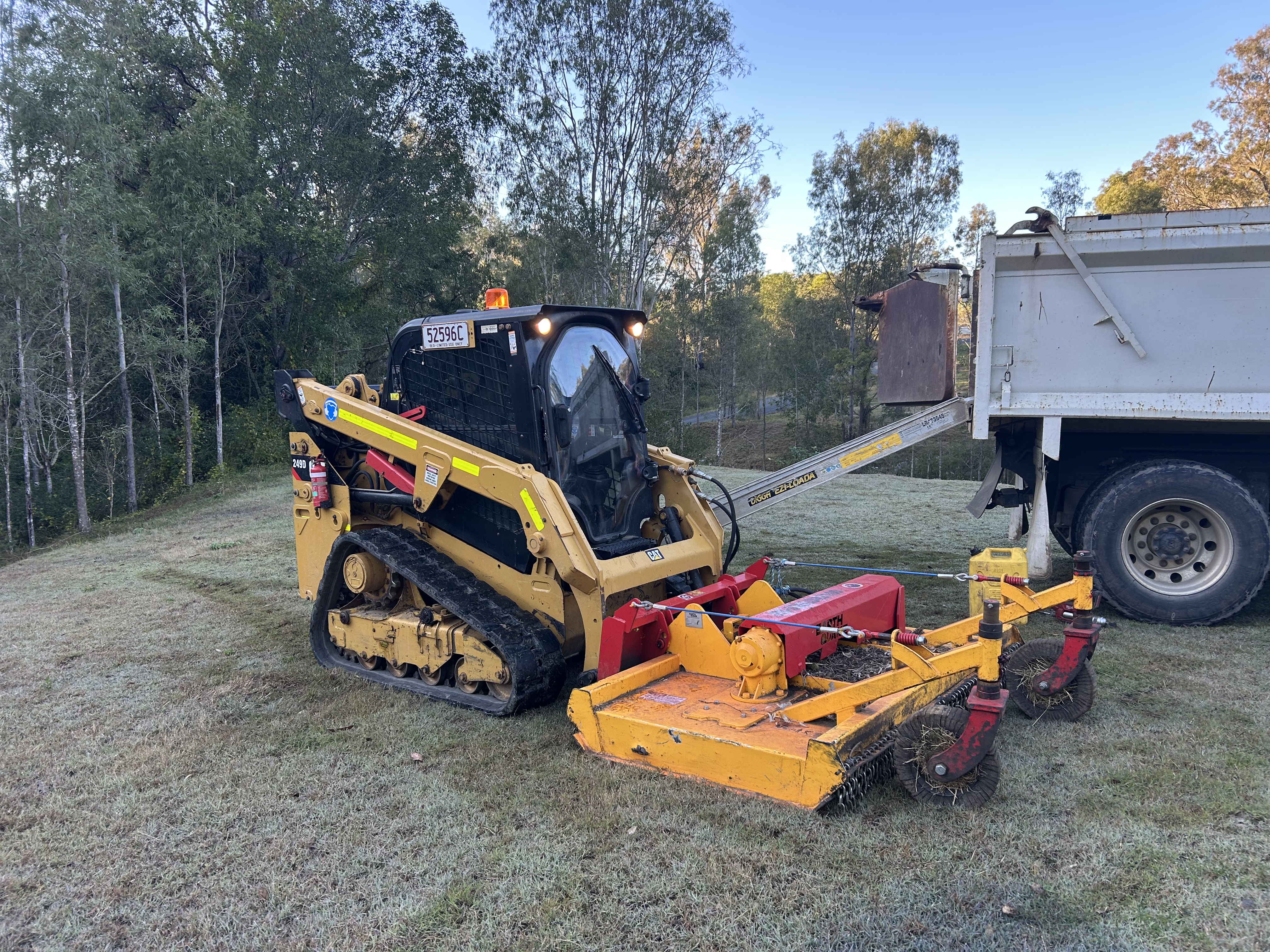 CAT posi track with slasher attachment ready for site preparation work