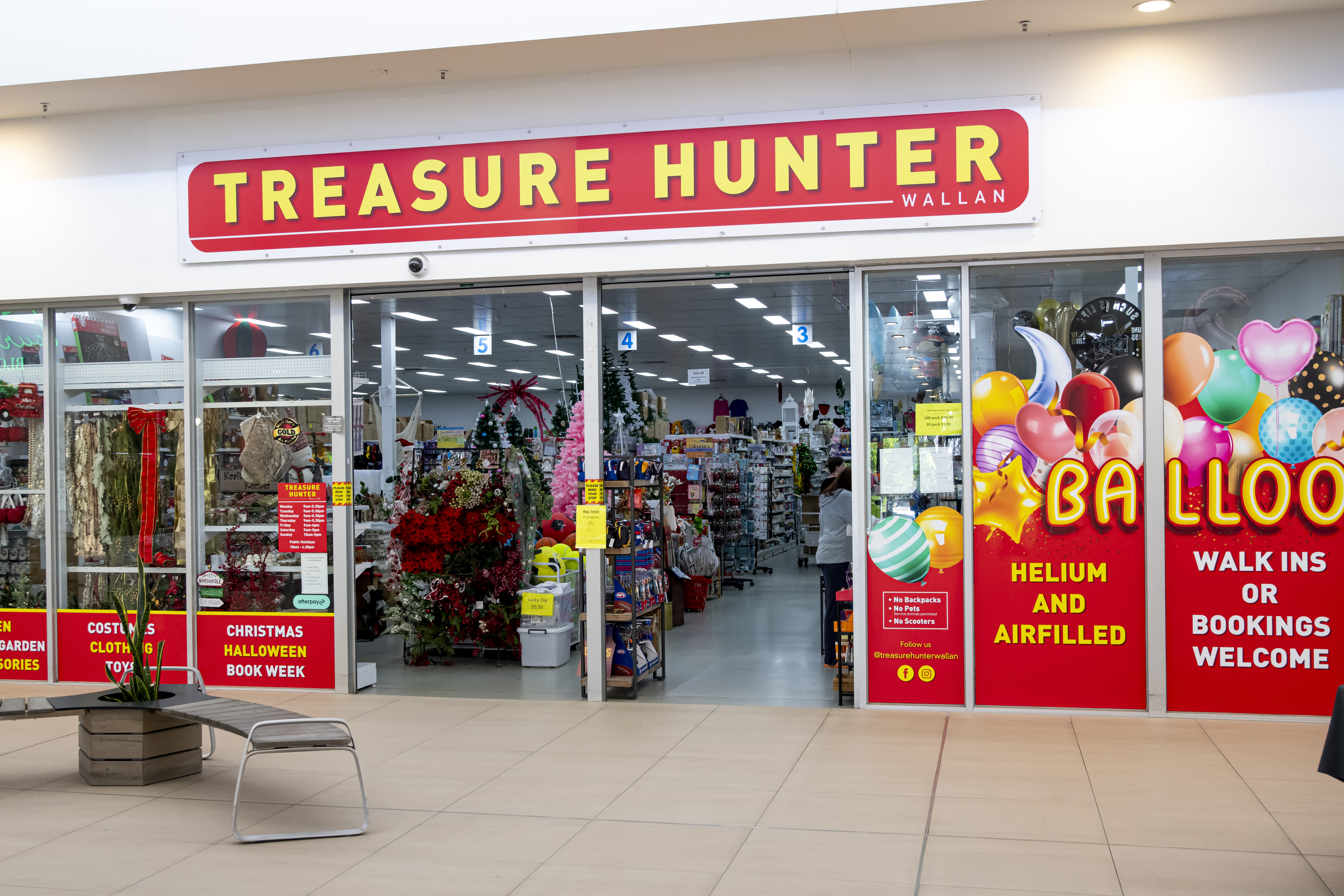 Treasure Hunter Wallan storefront at Wellington Square Shopping Centre — large discount variety store with red and yellow signage, balloons, party supplies, Christmas decorations and homewares visible through the shopfront