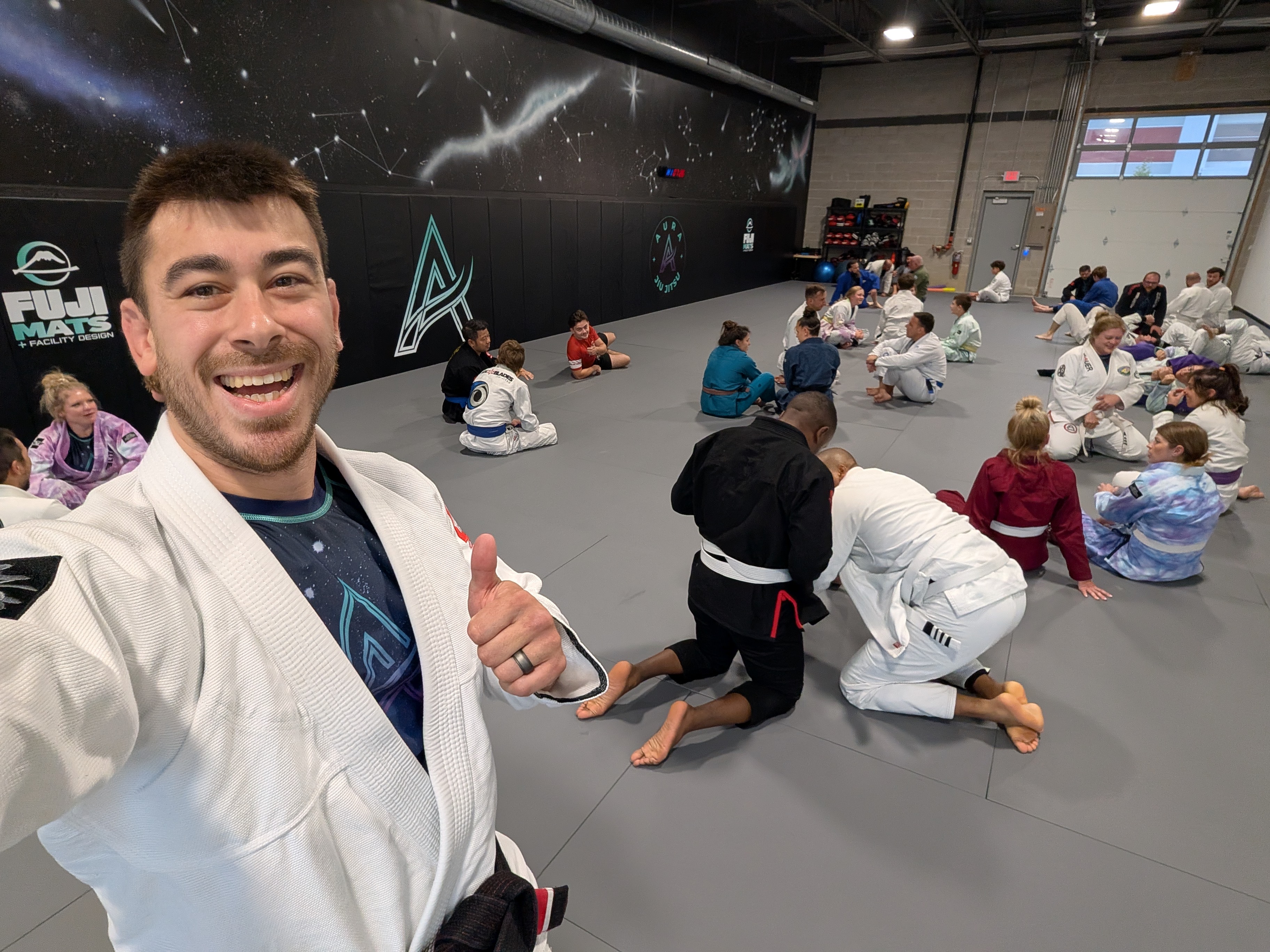 Aura Jiu Jitsu students training on the mats