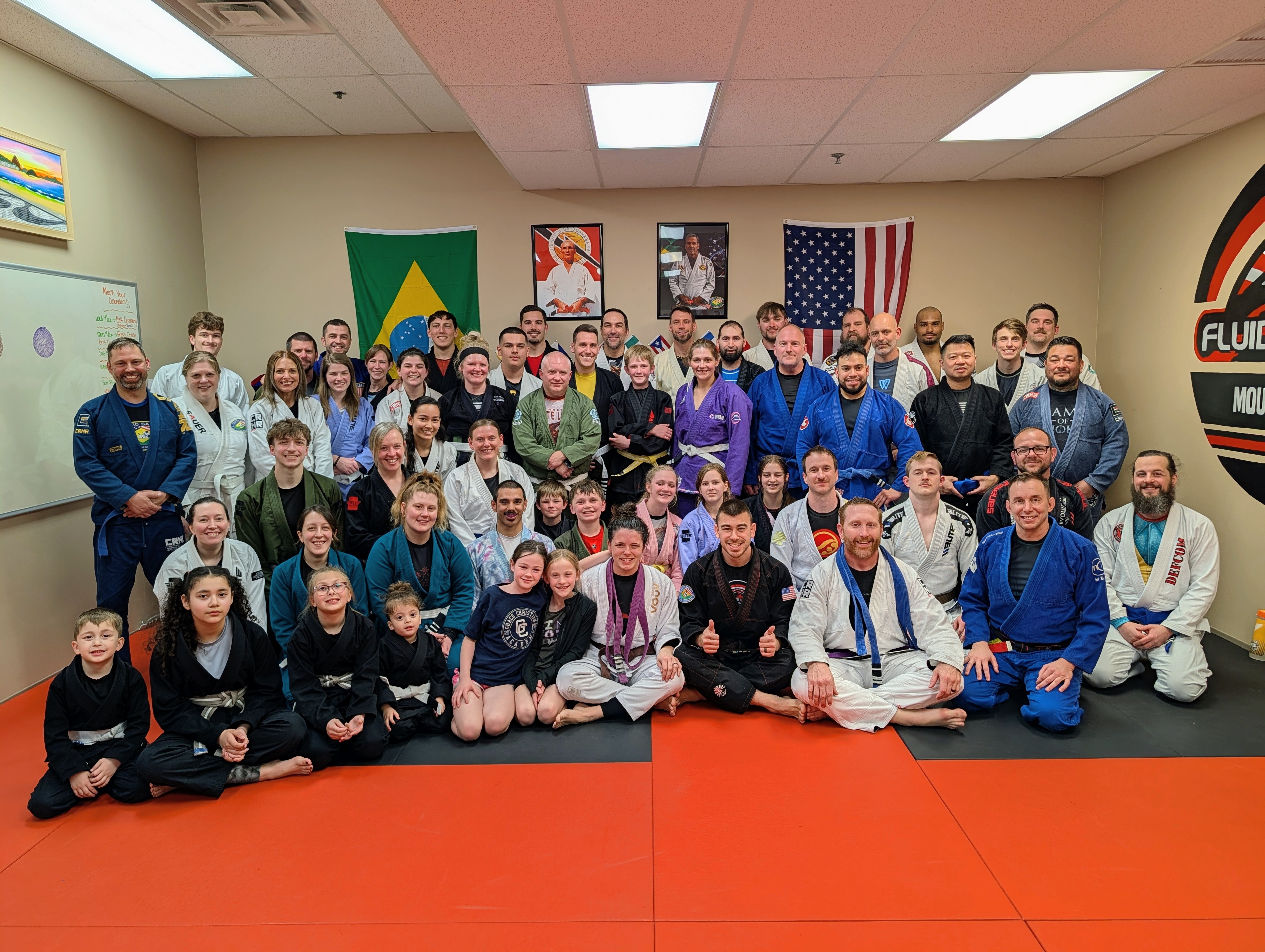 Aura Jiu Jitsu team — kids and adults on the mats in Mount Pleasant, WI