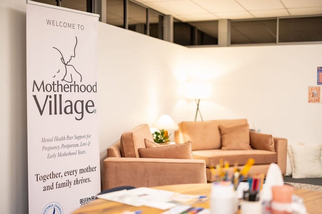 Motherhood Village — official branded image with Welcome to Motherhood Village banner