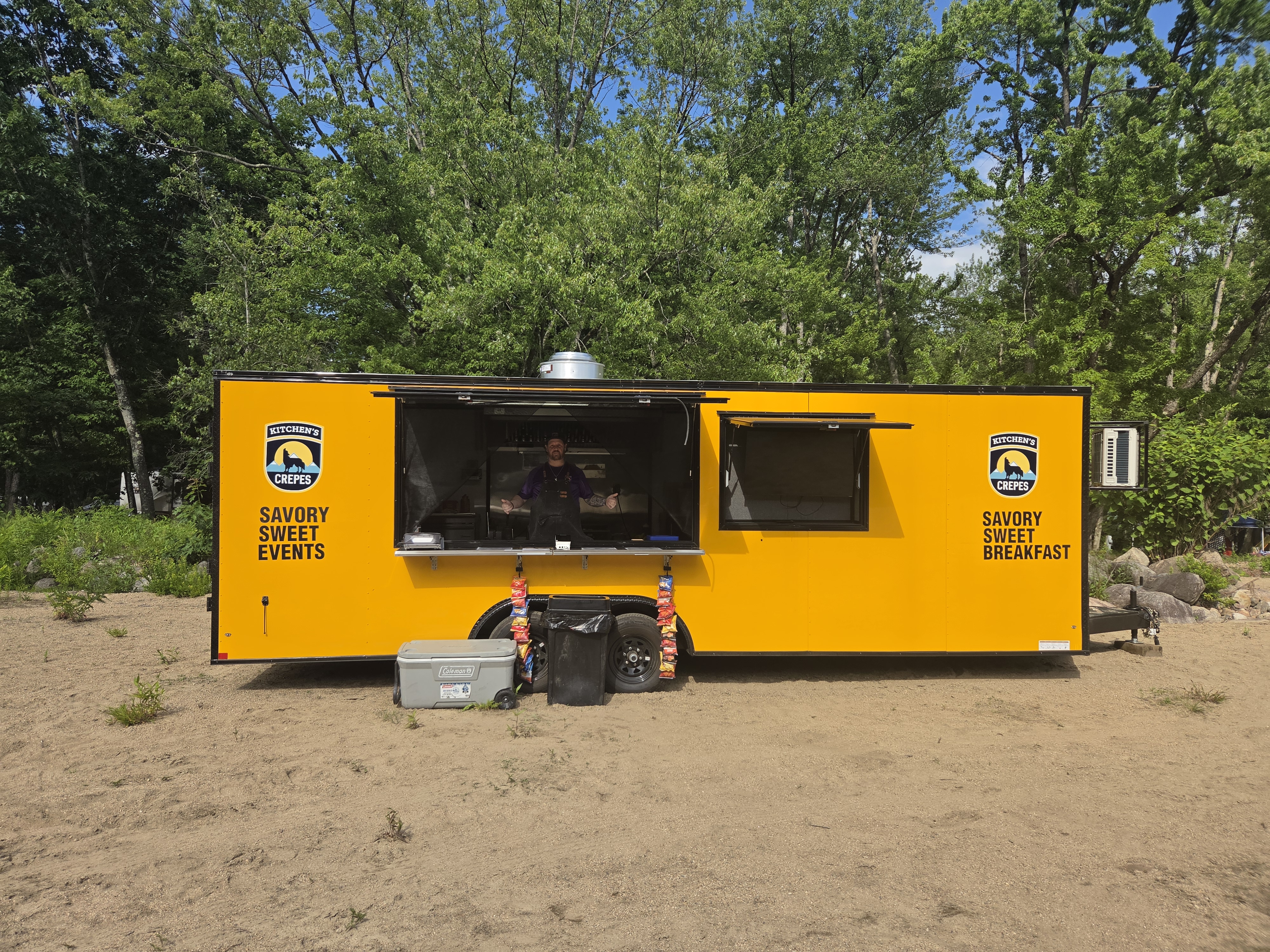 Kitchen's Crepes yellow trailer set up at an outdoor location