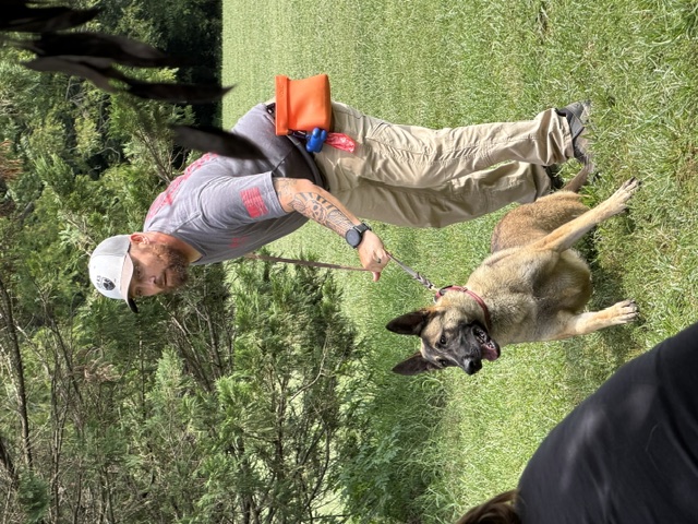 Sean Long with a Belgian Malinois in heel position